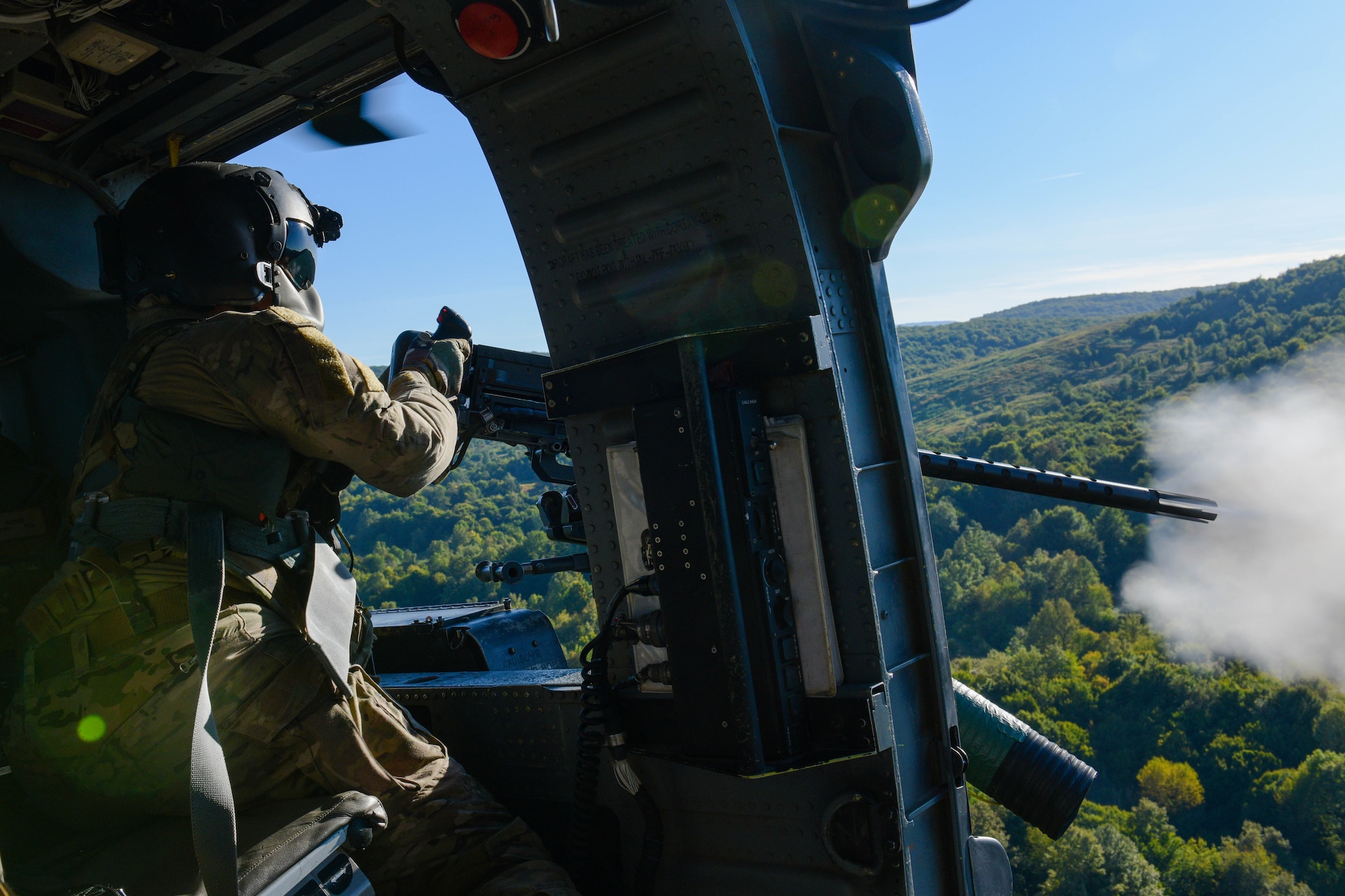 U.S. Air Force Staff Sgt. Kinga Hudson, 56th Rescue Squadron special missions aviator, performs training during a training sortie in Croatia Sept. 23, 2021. The HH-60G A6212 helicopter completed its final sortie before retirement and three crew members completed .50 caliber and mini gun training during the sortie. (U.S. Air Force photo by Senior Airman Brooke Moeder)