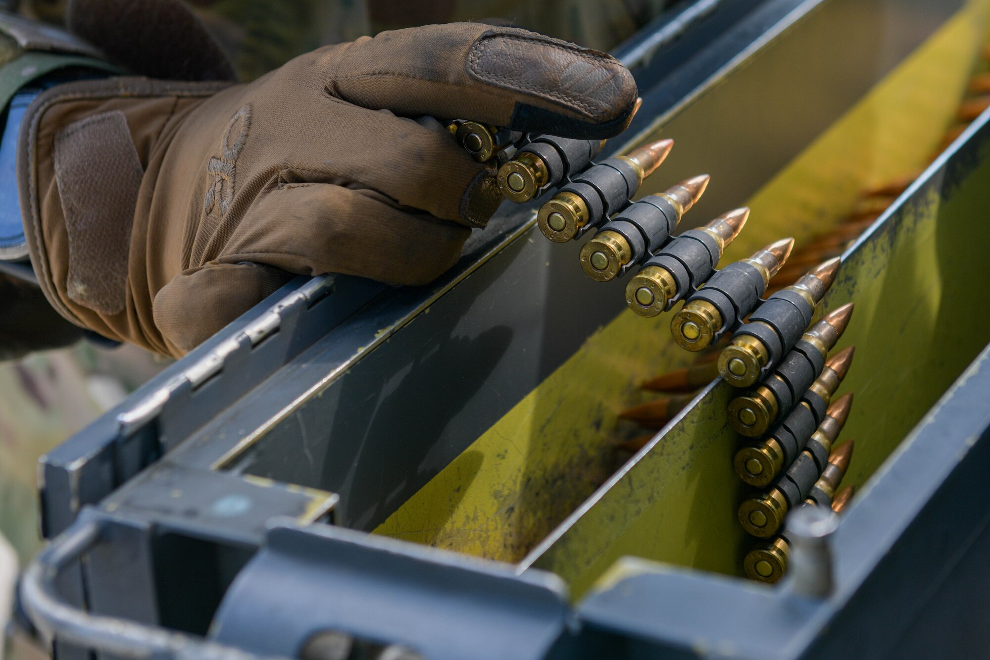 Ammunition is loaded onto an HH-60G Pave Hawk A6212 assigned to the 56th Rescue Squadron in preparation for a final sortie at Aviano Air Base, Italy, Sept. 23, 2021. The HH-60G helicopter completed its final sortie before retirement and the three crew members completed .50 caliber and mini gun training during the sortie. (U.S. Air Force photo by Senior Airman Brooke Moeder)