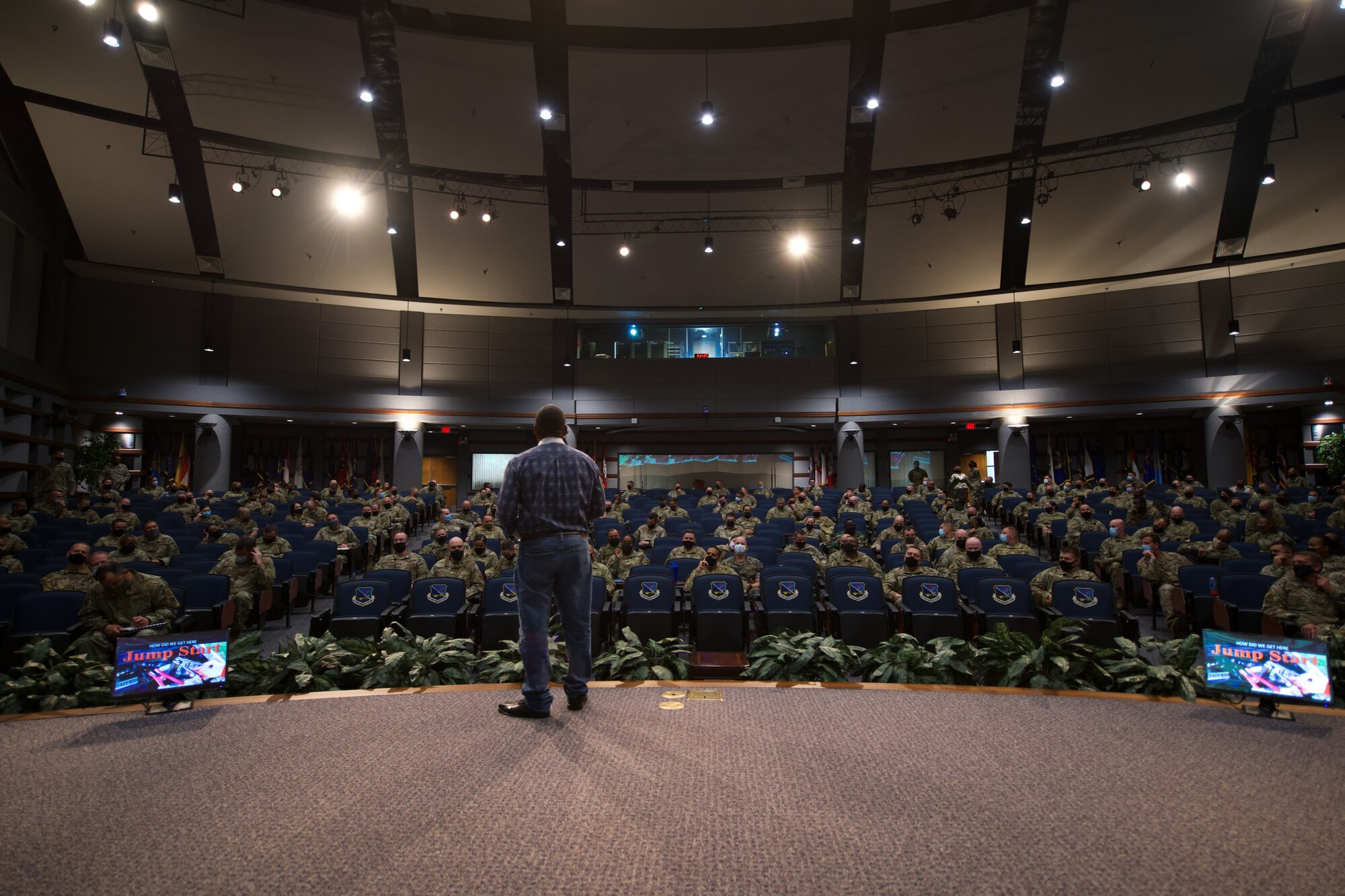 Photo of a speaker addressing students attending the SNCOA in a large auditorium.