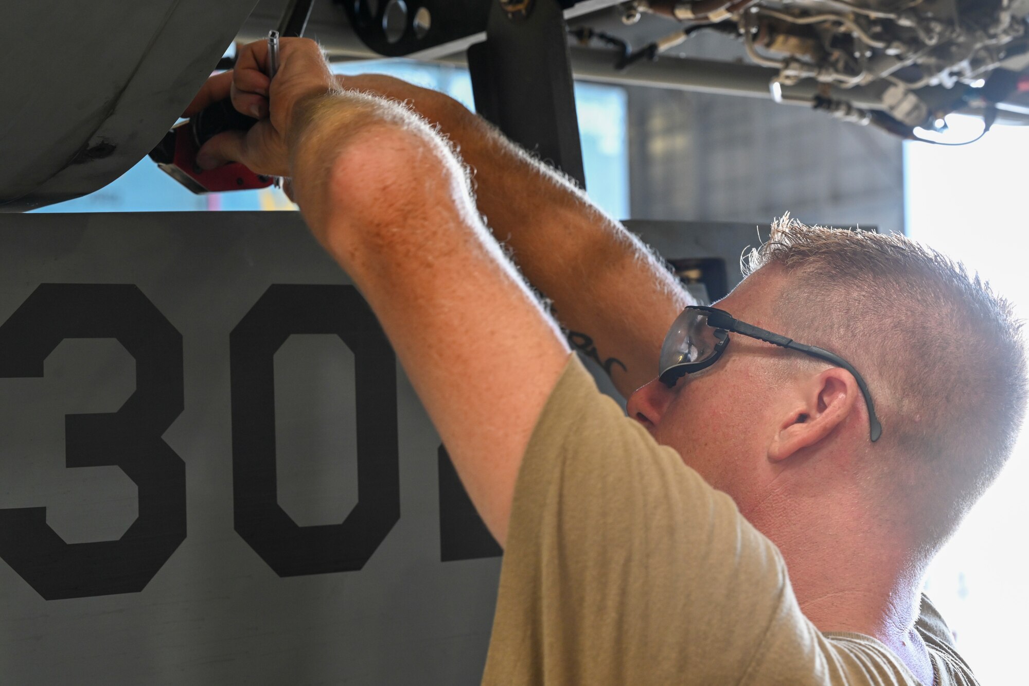 Master Sgt. Chance Cole, special mission aircraft program manager, builds an MQ-9 Reaper, Sept. 11, 2021, on Marine Corps Base Hawaii. Multiple MQ-9s were disassembled and placed in a “coffin” container for sealift transport to be used in Exercise Agile Combat Employment Reaper. (U.S. Air Force photo by Airman 1st Class Adrian Salazar)