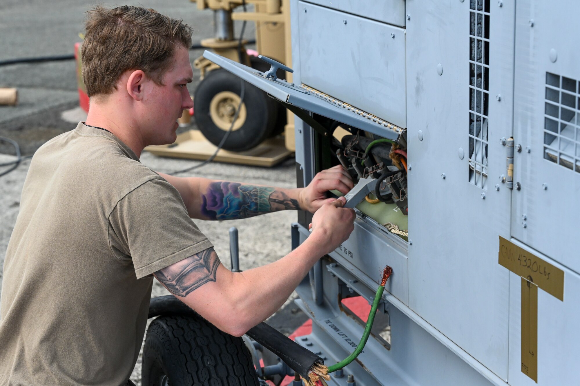 Staff Sgt. Colton Neal, 49th Aircraft Maintenance Squadron MQ-9 ground control station supervisor, wires equipment to a generator, Sept. 11, 2021, on Marine Corps Base Hawaii. Generators were used to power a ground control station, a containerized dual control segment, and multiple ground data terminals. (U.S. Air Force photo by Airman 1st Class Adrian Salazar)
