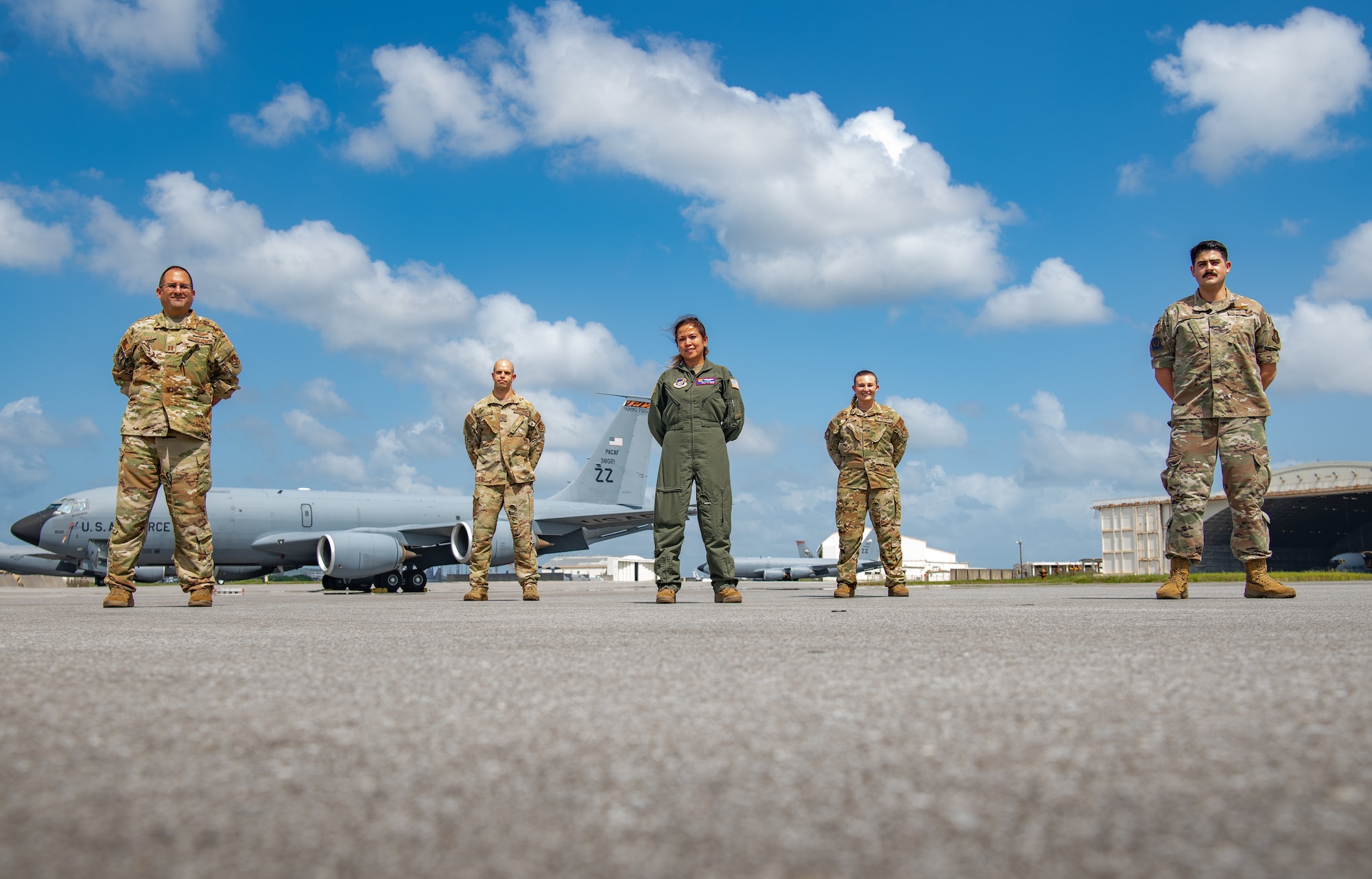 Five U.S. Air Force service members pose for a photo.