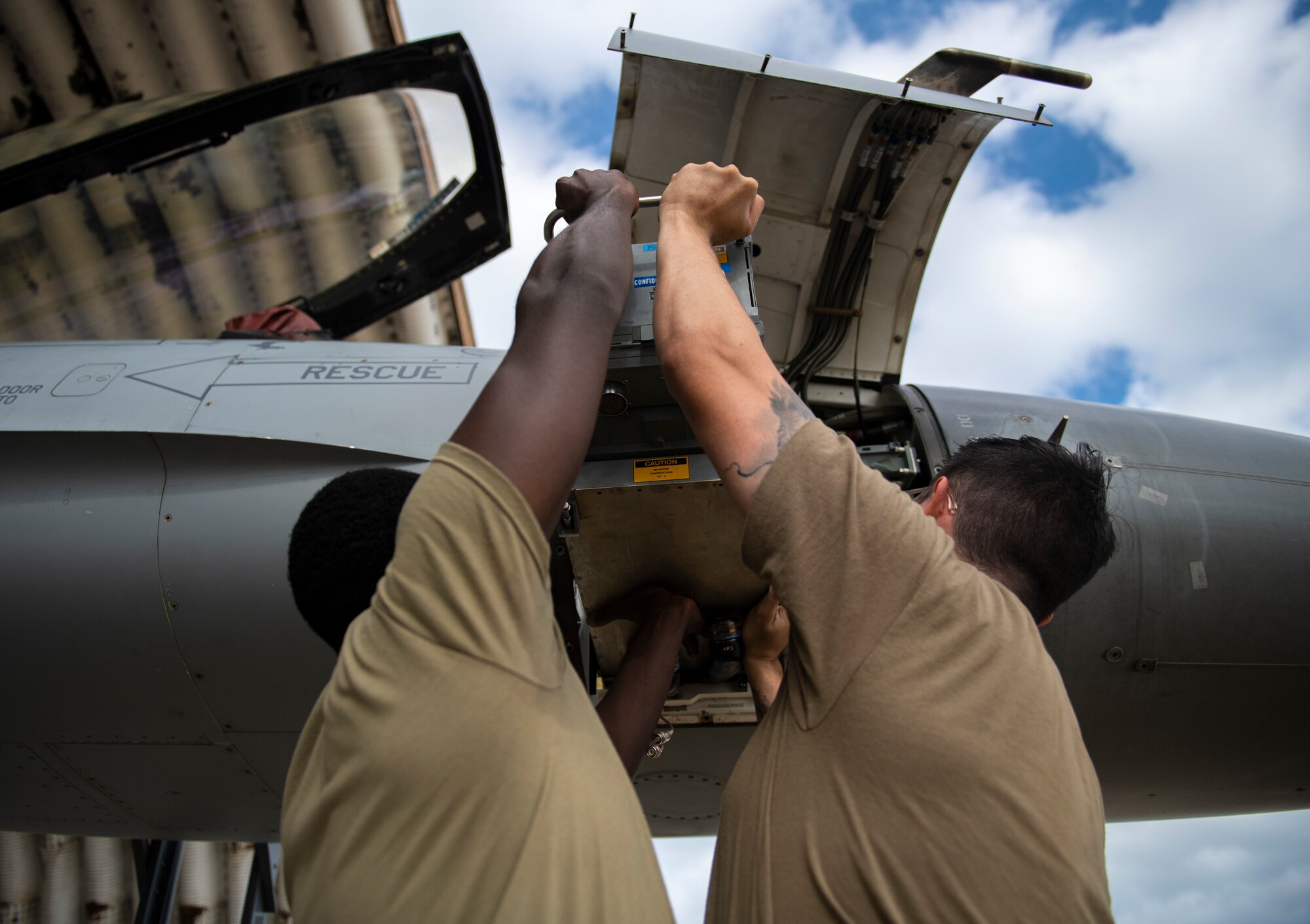 Senior Airmen Ian Njoroge and Chase Peace, 80th Aircraft Maintenance Unit avionics technicians, troubleshoot the fire control radar on an F-16 Fighting Falcon at Kunsan Air Base, Republic of Korea, Oct. 5, 2021. Avionics technicians are responsible for maintaining and repairing highly sophisticated avionics systems to ensure pilots receive the information they need to successfully operate their aircraft. (U.S. Air Force photo by Senior Airman Suzie Plotnikov)