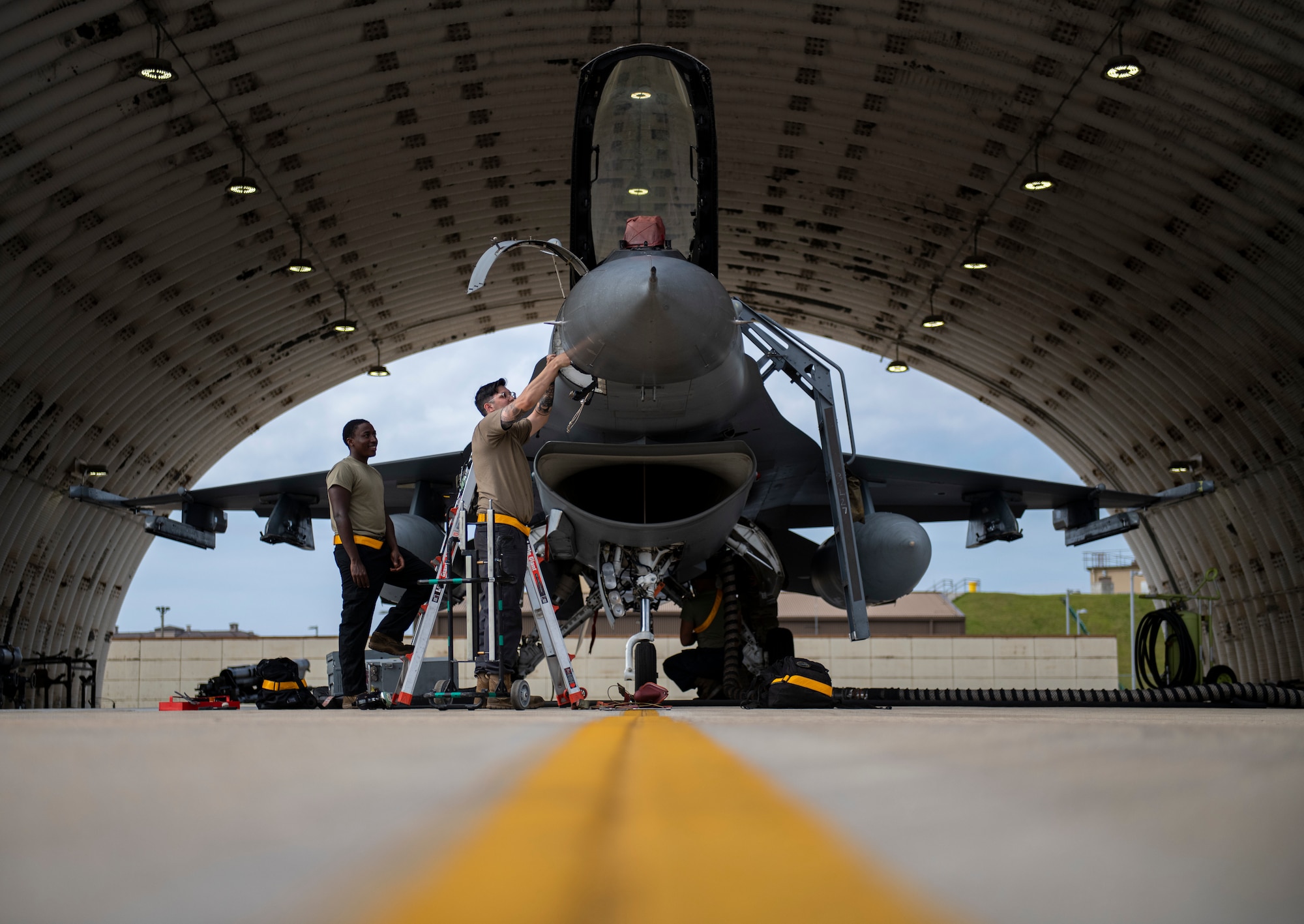 Senior Airmen Ian Njoroge and Chase Peace, 80th Aircraft Maintenance Unit avionics technicians, troubleshoot the fire control radar on an F-16 Fighting Falcon at Kunsan Air Base, Republic of Korea, Oct. 5, 2021. The F-16 is an all-weather, multi-role fighter aircraft, capable of air-to-air combat and air-to-surface attack. (U.S. Air Force photo by Senior Airman Suzie Plotnikov)