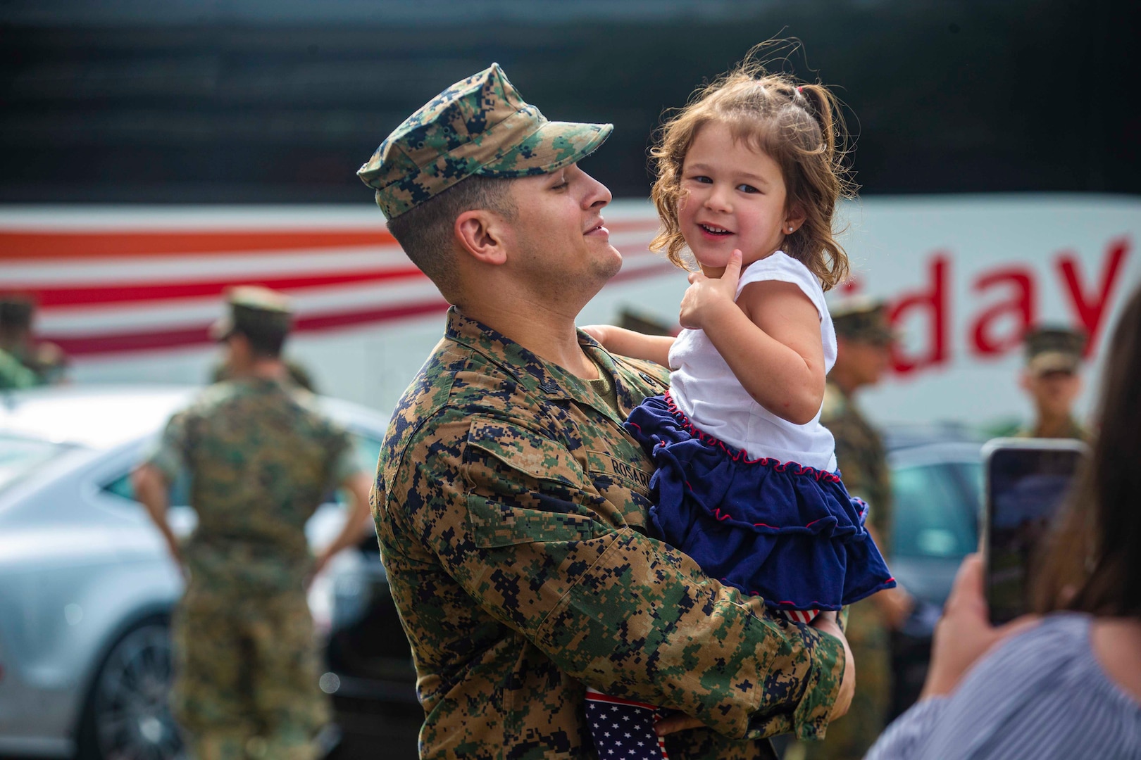 A Marine holds a child.