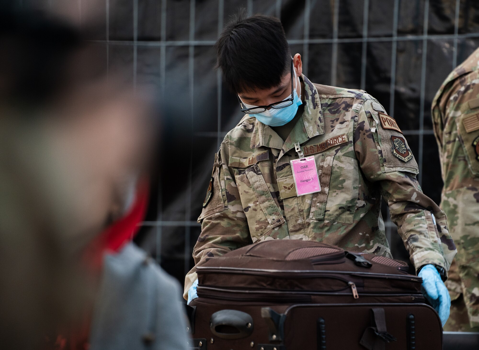 Airman checks luggage.