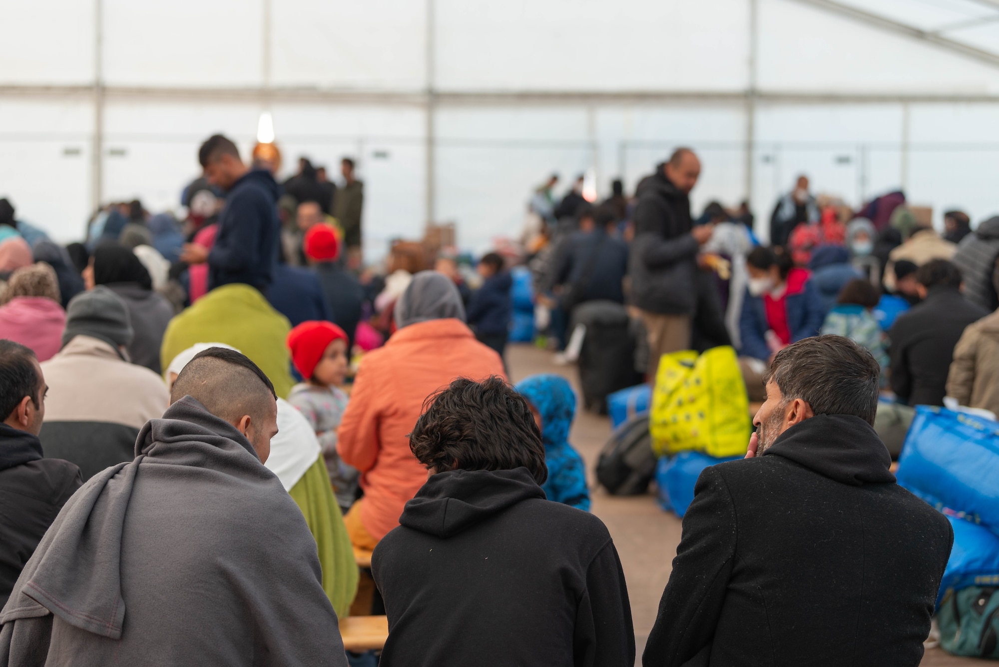 Evacuees wait to be processed in passenger terminal.