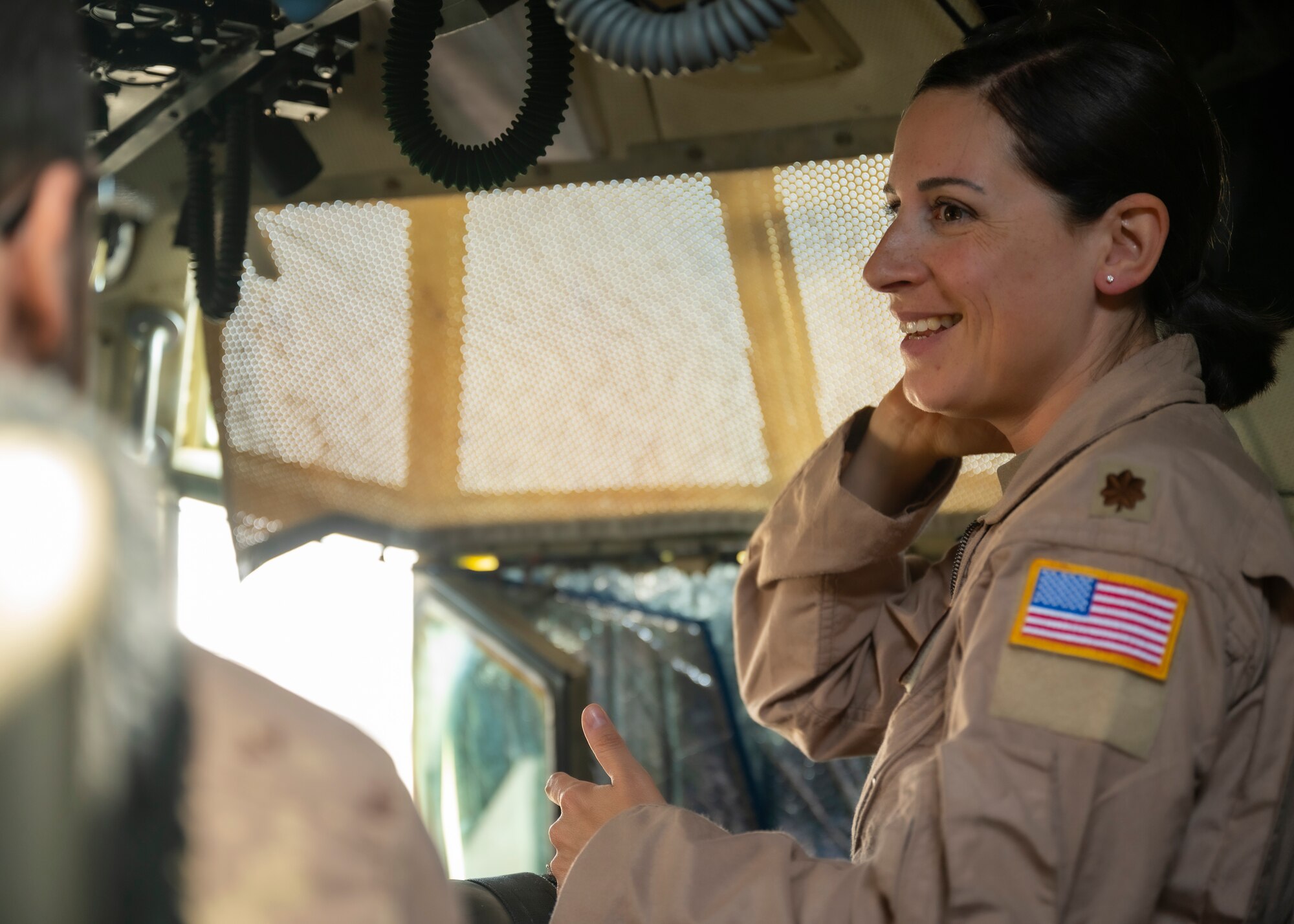 U.S. Air Force Maj. Natalie Marshall, a pilot assigned to the 779th Expeditionary Airlift Squadron, interacts with visitors during a C-130H Hercules tour at Ali Al Salem Air Base, Kuwait, Oct. 9, 2021.