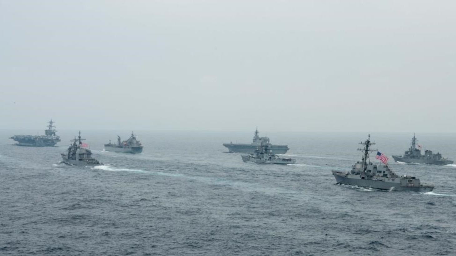 BAY OF BENGAL (Oct. 12, 2021)  U.S. Navy Nimitz-class aircraft carrier USS Carl Vinson (CVN 70), U.S. Navy Ticonderoga-class guided-missile cruiser USS Lake Champlain (CG 57), Royal Australian Navy fleet replenishment vessel HMAS Sirius (O 266), Japan Maritime Self-Defense Force (JMSDF) Izumo-class helicopter destroyer JS Kaga (DDH 184), Royal Indian Navy Rajput-class destroyer INS Ranvijay (D55), U.S. Navy Arleigh Burke-class guided-missile destroyer USS Stockdale (DDG 106) and JMSDF Murasame-class destroyer JS Murasame (DD 101) transit the Bay of Bengal as part of MALABAR 2021, Oct. 12, 2021. MALABAR 2021 is a maritime exercise designed to improve integration, address common maritime security priorities and concerns, enhance interoperability and communication, and strengthen enduring relationships between the Royal Australian Navy, Royal Indian Navy, JMSDF, and U.S. maritime forces. (U.S. Navy photo by Mass Communication Specialist 2nd Class Russell Lindsey)