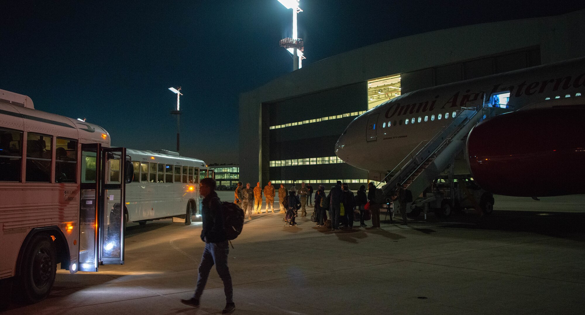 Evacuees board outbound flight.