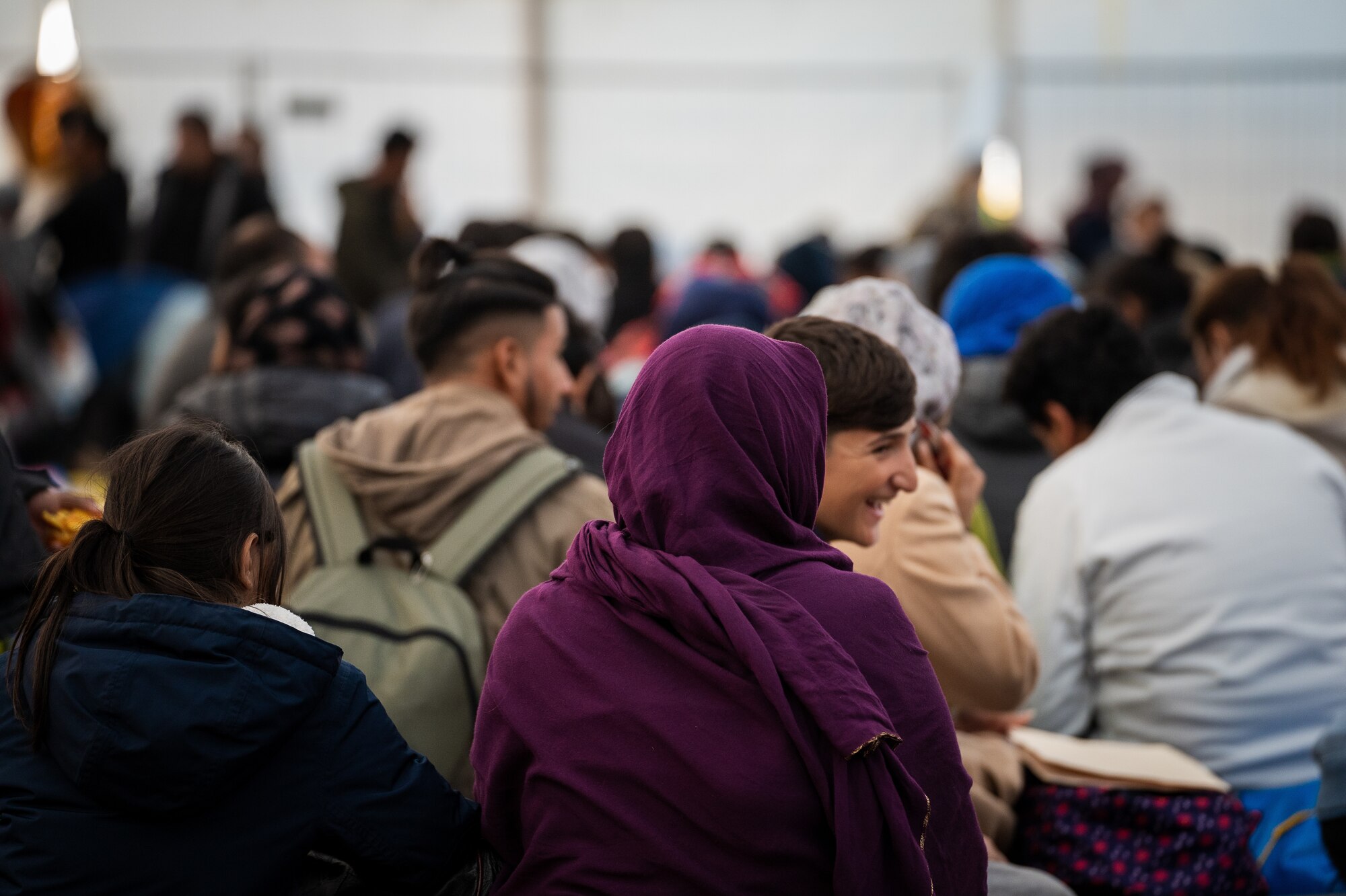 Evacuees wait in passenger terminal.