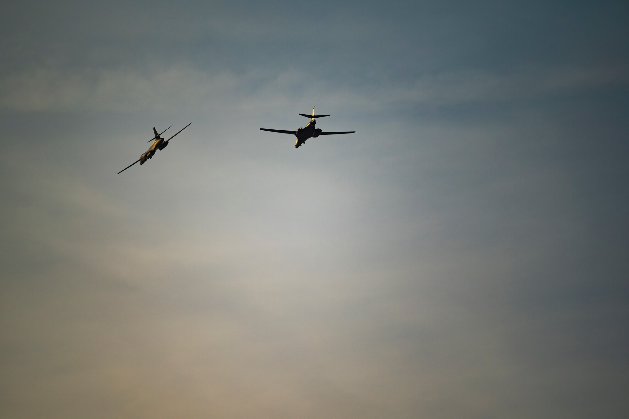 Two B-B Lancers assigned to the 9th Expeditionary Bomb Squadron, fly over RAF Fairford, United Kingdom, Oct. 11, 2021. Both aircraft supported a Bomber Task Force Europe training mission where they conducted a hot pit refueling at Spangdahlem Air Base, Germany. Hot pit refueling showcases the 9th EBS ability to implement Agile Combat Employment while operating in unfamiliar locations. (U.S. Air Force photo by Senior Airman Colin Hollowell)