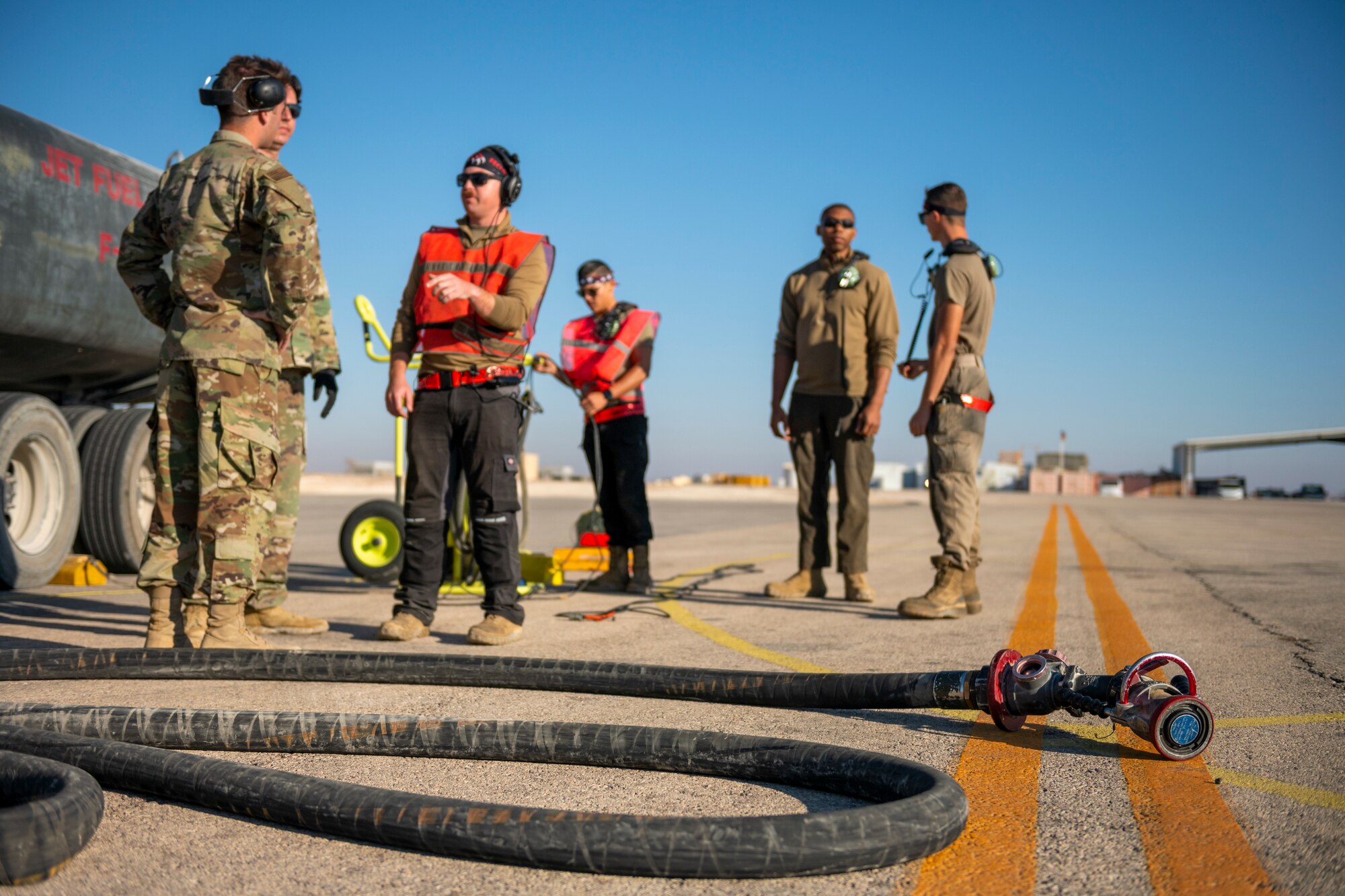 U.S. Airmen from the 332nd and 378th Air Expeditionary Wings conduct hot pit refueling of two U.S. F-16 Fighting Falcons Sept. 30, 2021, at an undisclosed location in Southwest Asia. The F-16s were forward-deployed from the 378th AEW, Prince Sultan Air Base, Kingdom of Saudi Arabia. Maintenance crews assigned to the 332nd and 378th AEWs conducted a hot-pit refueling training exchange over the course of several weeks, increasing their agile combat employment capabilities by ensuring both F-16 Fighting Falcons and F-15E Strike Eagles can be refueled by each wing. (U.S. Air Force photo by Master Sgt. Traci Keller)