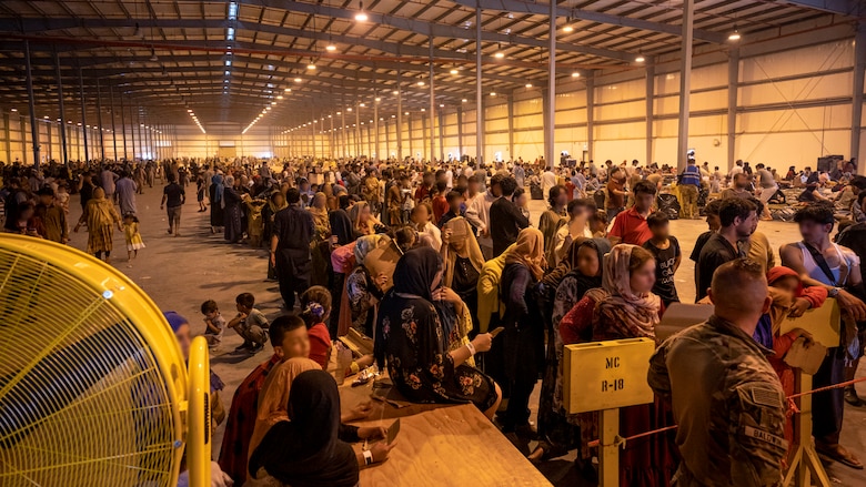 Afghanistan evacuees line up for supplies at one of the operating locations, Aug. 23, 2021, at Al Udeid Air Base, Qatar.