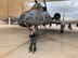 A photo of a pilot standing next to an A-10 Thunderbolt II aircraft.