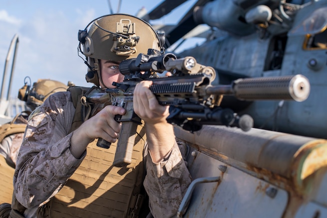 ARABIAN SEA (Oct. 7, 2021) Marine Corps Lance Cpl. David Wells, a rifleman assigned to Alpha Company, Battalion Landing Team 1/1, 11th Marine Expeditionary Unit (MEU), posts security on the flight deck during an interior and exterior clearing exercise aboard amphibious transport dock USS Portland (LPD 27), Oct. 7. Portland and the 11th MEU are deployed to the U.S. 5th Fleet area of operations in support of naval operations to ensure maritime stability and security in the Central Region, connecting the Mediterranean and Pacific through the Western Indian Ocean and three strategic choke points. (U.S. Marine Corps photo by Lance Cpl. Patrick Katz/Released)