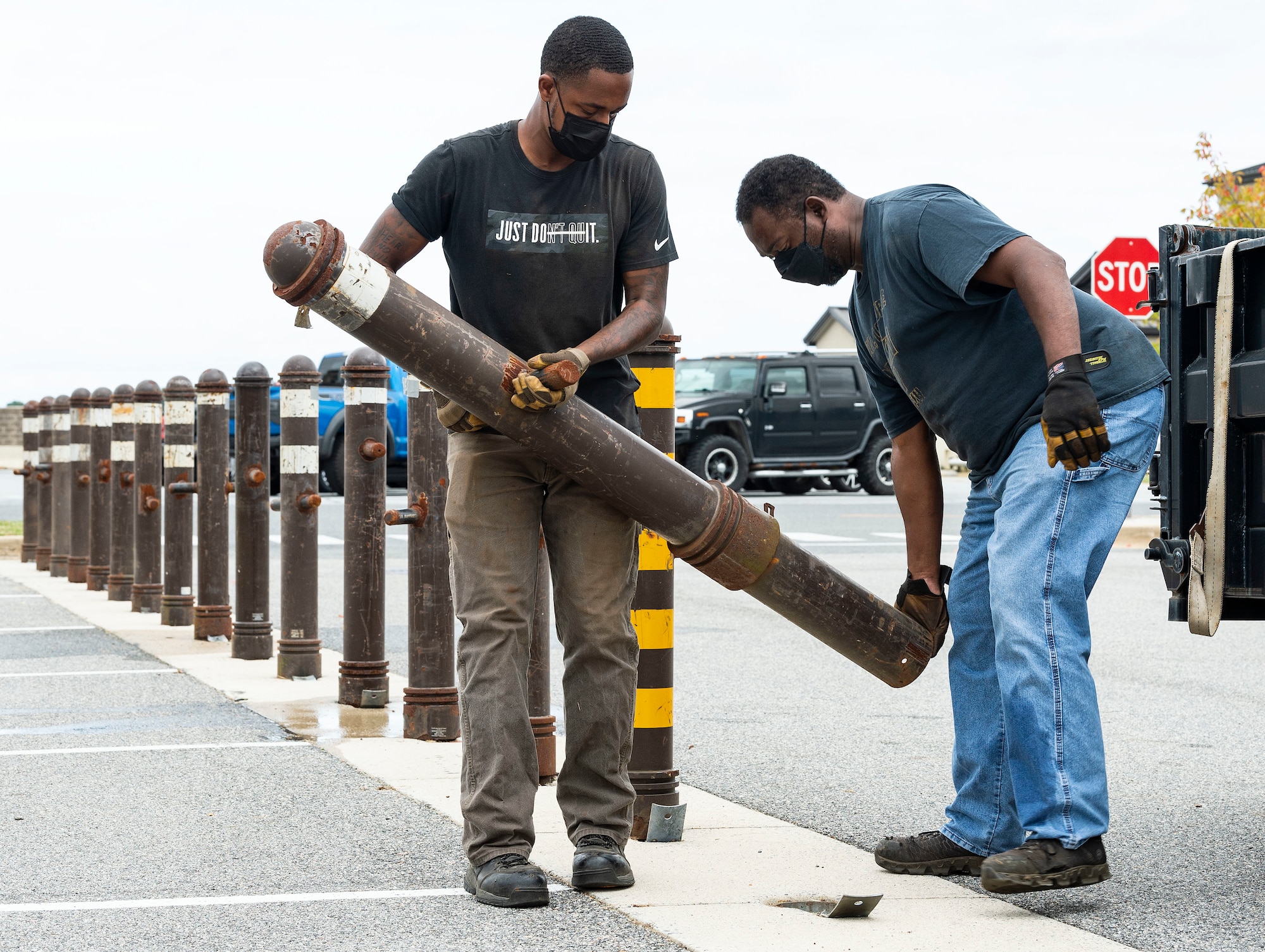 From the left, Kevonte Jackson and Earl Batten, both from the 436th Civil Engineer Squadron horizontal shop, install bollards during a Force Protection Major Accident Response Exercise at Dover Air Force Base, Delaware, Oct. 6, 2021. The three-day exercise tested the response capabilities of Team Dover through various scenarios in an effort to strengthen their ability to provide rapid-global mobility in challenging conditions. (U.S. Air Force photo by Roland Balik)