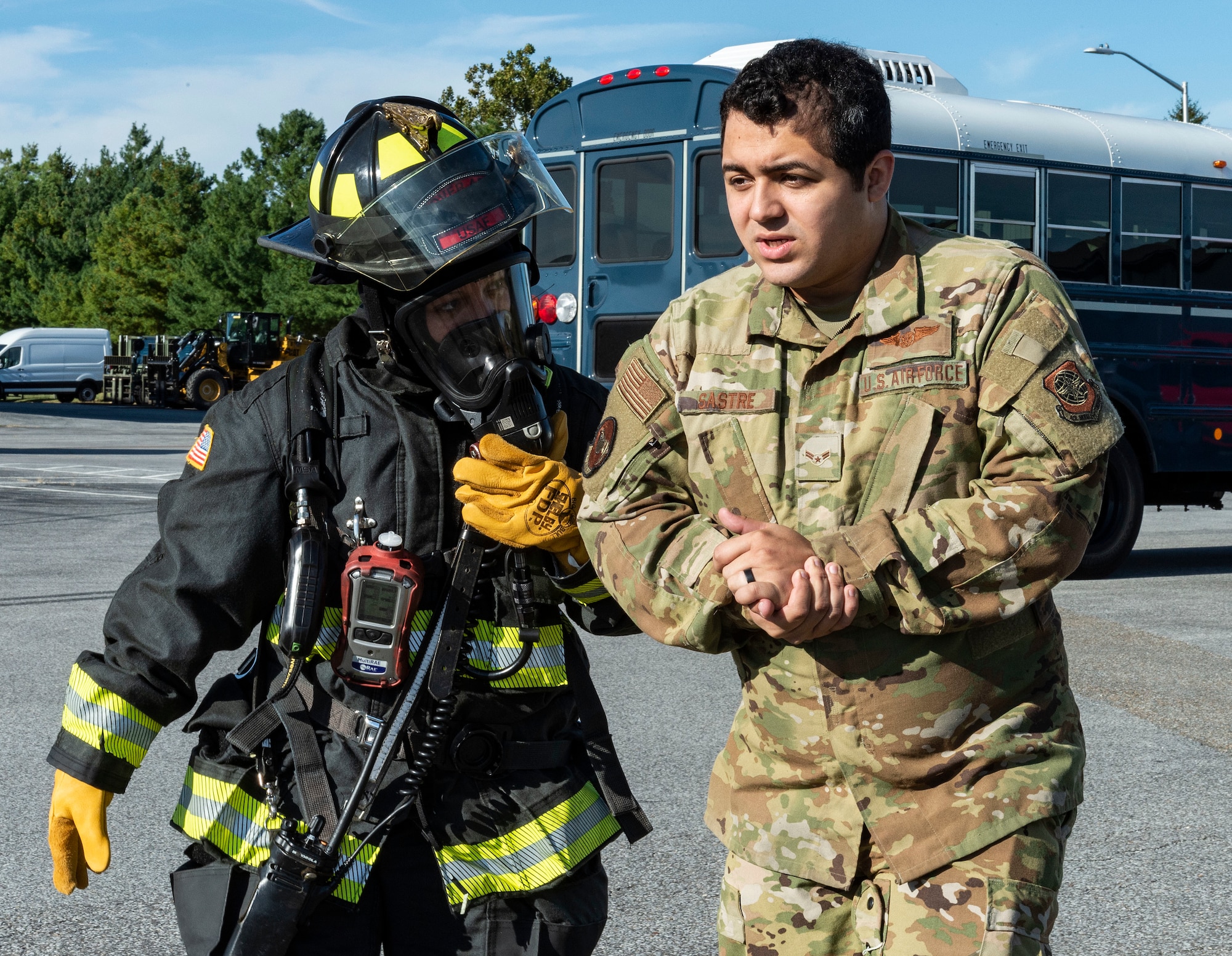 Maria Quinones, right, 436th Civil Engineer Squadron fire department firefighter, escorts Airman 1st Class Miguel Sastre, 9th Airlift Squadron loadmaster, to a triage area during a Force Protection Major Accident Response Exercise at Dover Air Force Base, Delaware, Oct. 7, 2021. The three-day exercise tested the response capabilities of Team Dover through various scenarios in an effort to strengthen their ability to provide rapid-global mobility in challenging conditions. (U.S. Air Force photo by Roland Balik)