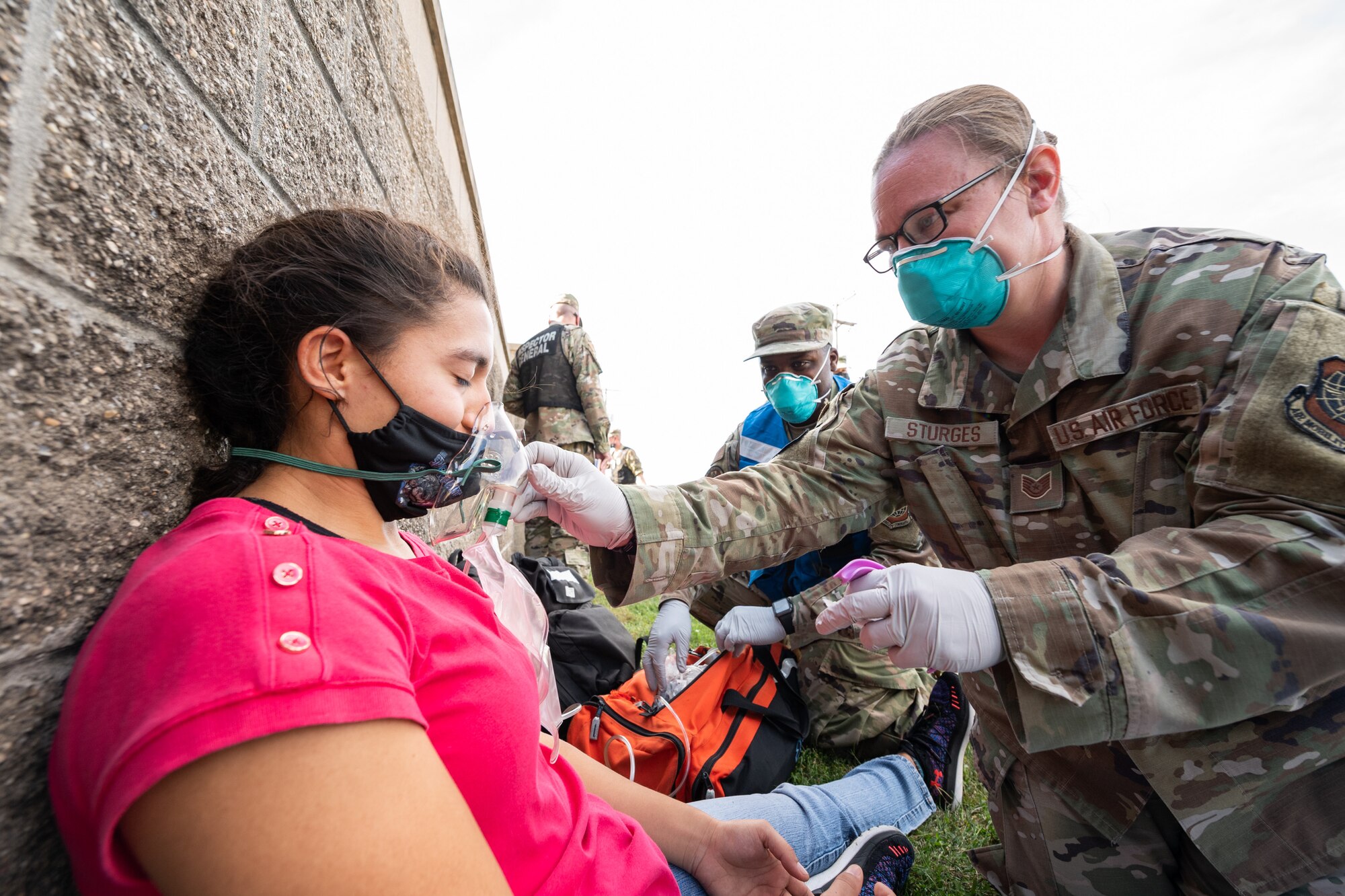 Tech. Sgt. Kimberly Sturges, 436th Operational Medical Readiness Squadron base operational medical clinic noncommissioned officer in charge, renders first aid to a victim after a simulated active shooter during a Force Protection Major Accident Response Exercise at Dover Air Force Base, Delaware, Oct. 7, 2021. The three-day exercise tested the resolve of Team Dover through various scenarios in an effort to strengthen their ability to provide rapid-global mobility in challenging conditions.(U.S. Air Force photo by Mauricio Campino)