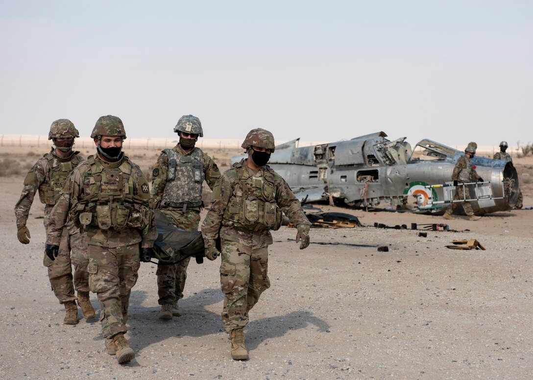 Air Force and Army Servicemembers carry litter with simulated casualty at Ali al Salem Air Base, Kuwait, November 6, 2020, during training for handling remains after major accident (U.S. Air Force/Kaleb Mayfield)