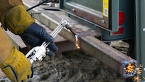 A student from the Center for Technology Essex uses an oxy-acetylene torch to cut a strip of metal at the Camp Ethan Allen Training Site in Jericho, Vermont, on Oct. 12, 2021. Students from CTE visited CEATS to gain hands-on experience with heavy equipment from Vermont Army National Guard Soldiers. (U.S. Army National Guard photo by Sgt. Dyllan Durham)