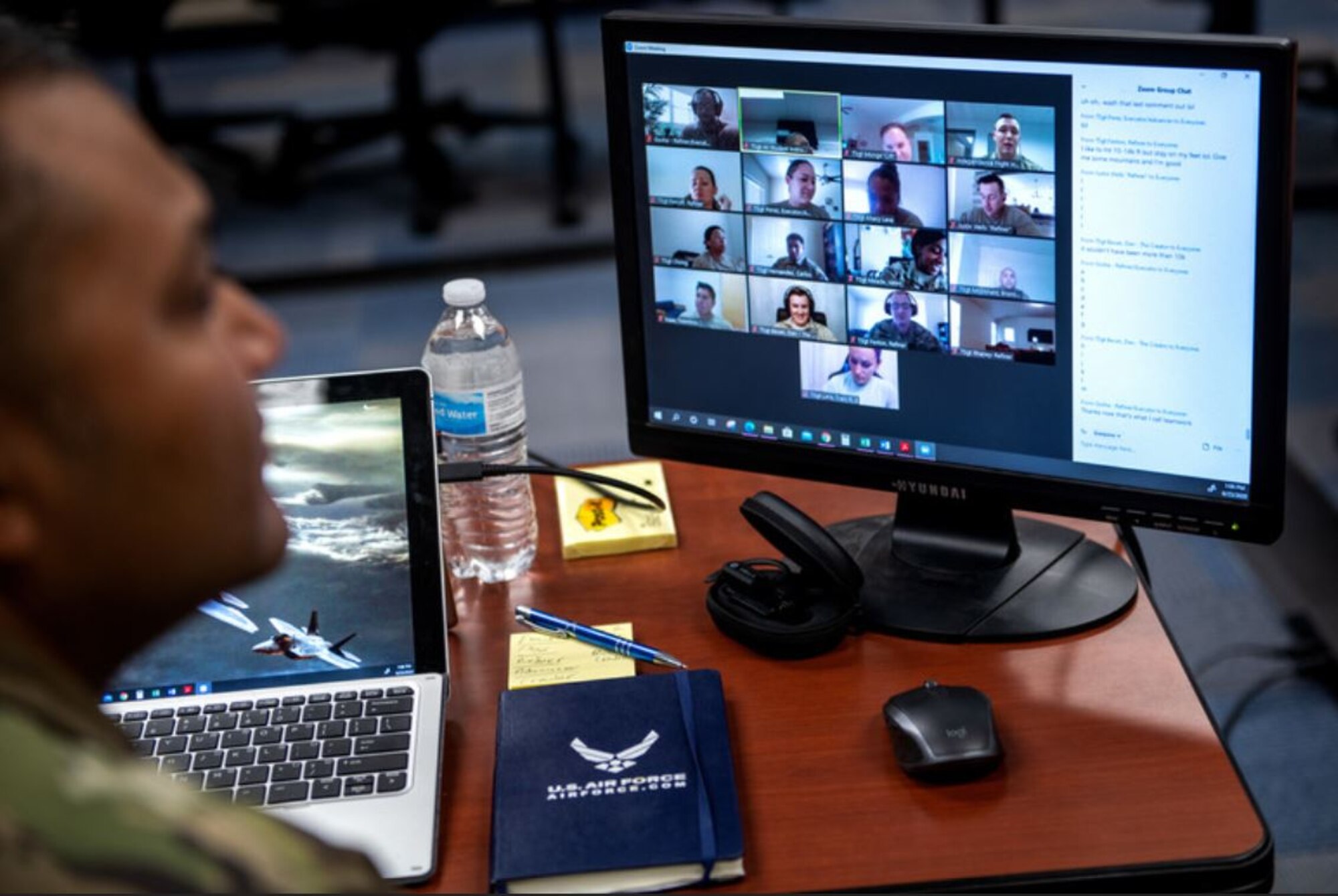 Airman looking at computer monitor during virtual meeting