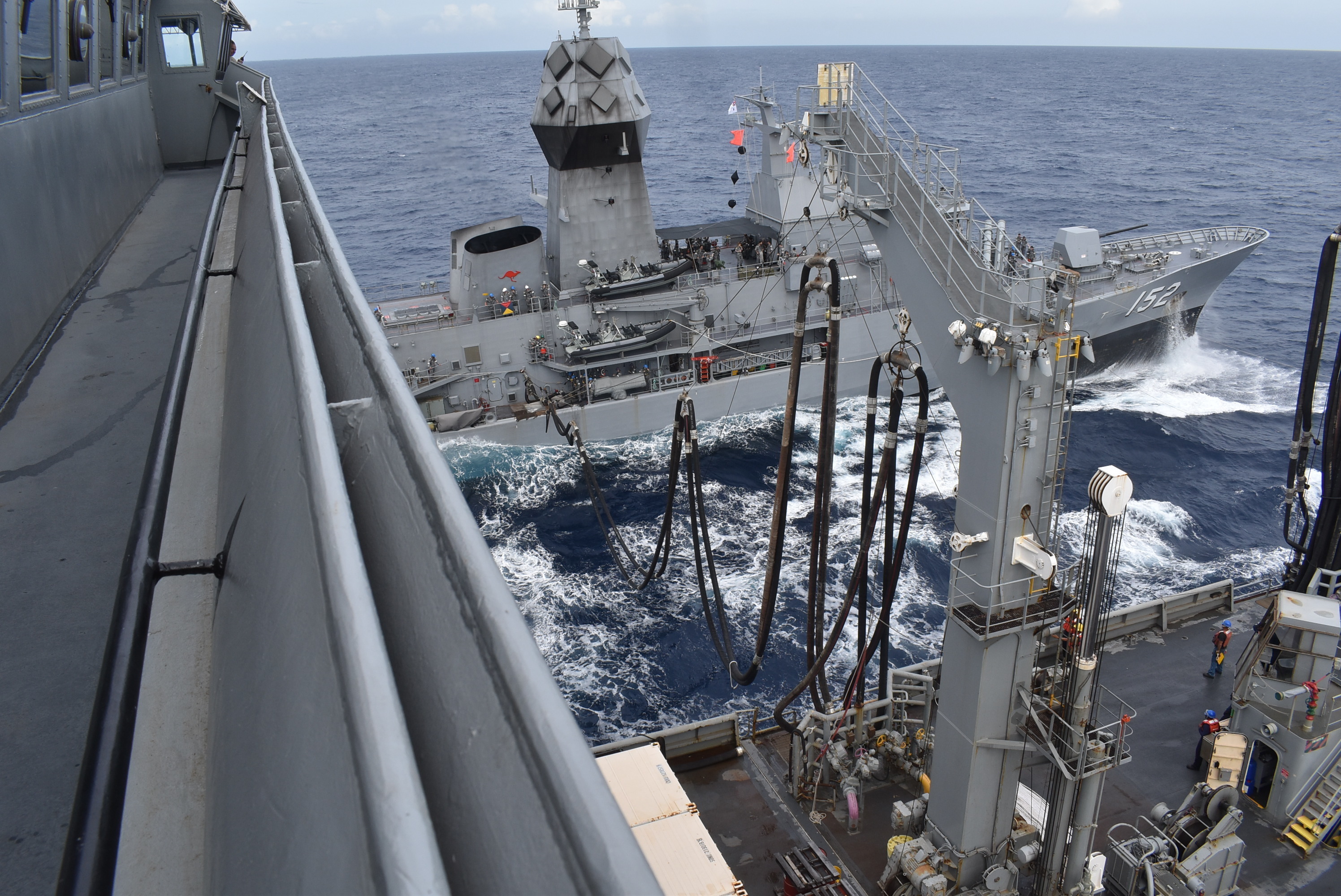 USNS Big Horn (T-AO 198) conducts an underway replenishment, providing fuel and other critical supplies, with the Royal Australian Navy Anzac-class frigate HMAS Warramunga (FFH 152).