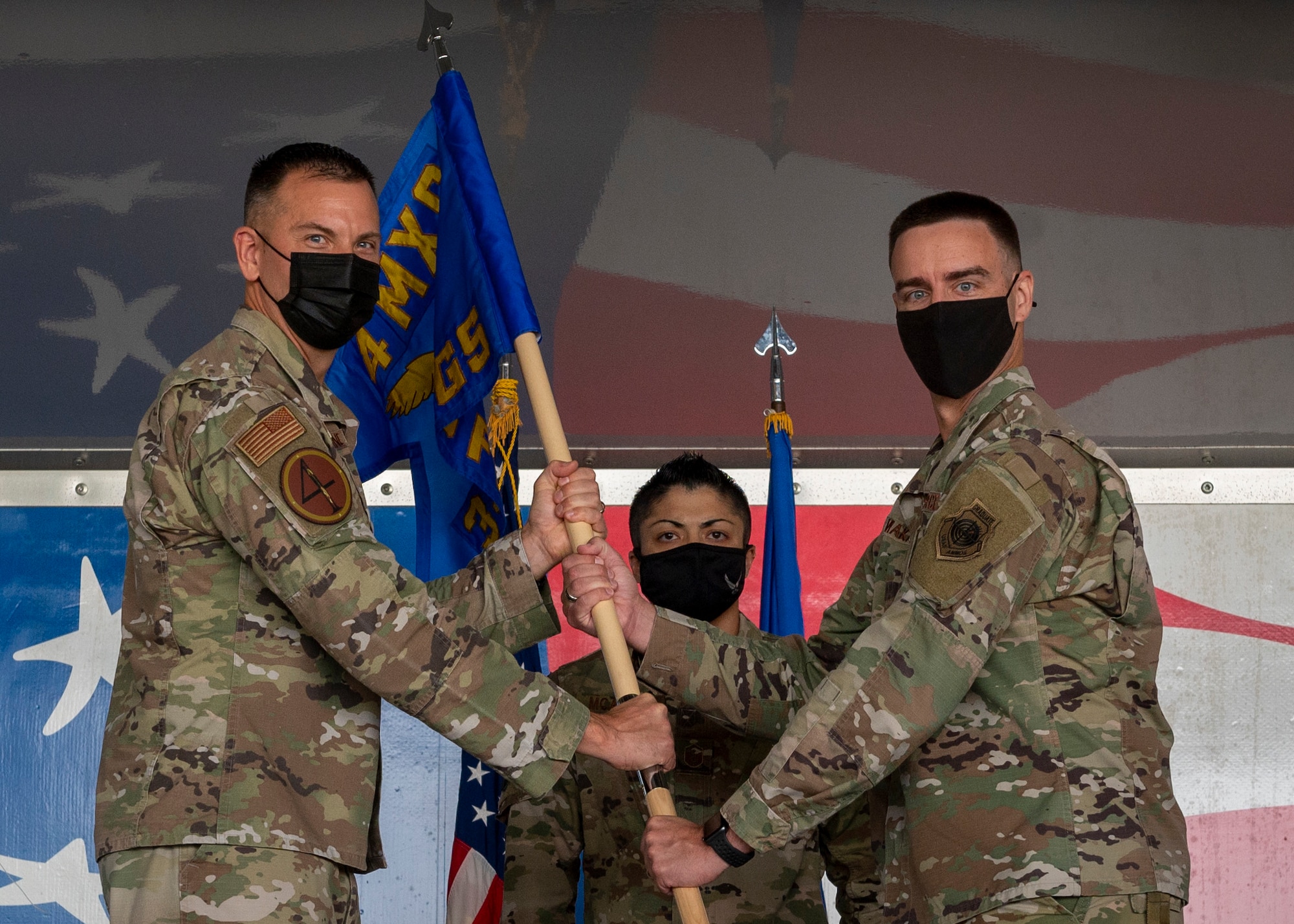 Maj. Michael Makaryk, right, former 4th Aircraft Maintenance Squadron commander, receives the 335th Fighter Generation Squadron guidon from Col. Kurt Helphinstine, 4th Fighter Wing commander, during the FGS’s activation ceremony at Seymour Johnson Air Force Base, North Carolina, Sept. 29, 2021.