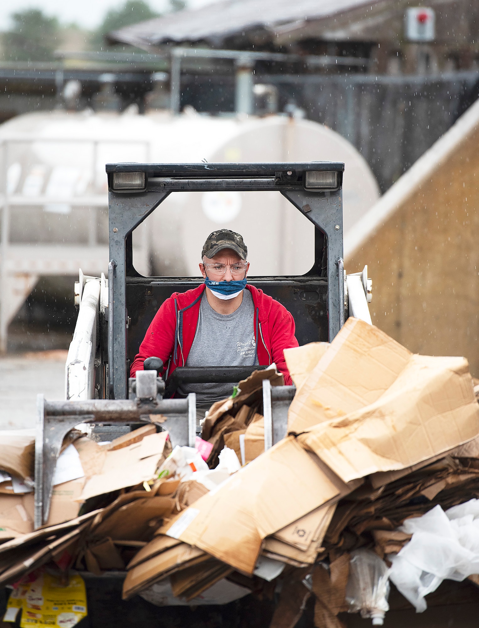 Dave Matheney, 88th Force Support Squadron, brings a load of mostly cardboard into the Recycling Center at Wright-Patterson Air Force Base, Ohio, on Sept. 22, 2021, for sorting and baling. Plastic in the lower right is the type of contaminant that comes from people throwing trash and other material into the wrong bin, adding labor and expense to the recycling process. (U.S. Air Force photo by R.J. Oriez)