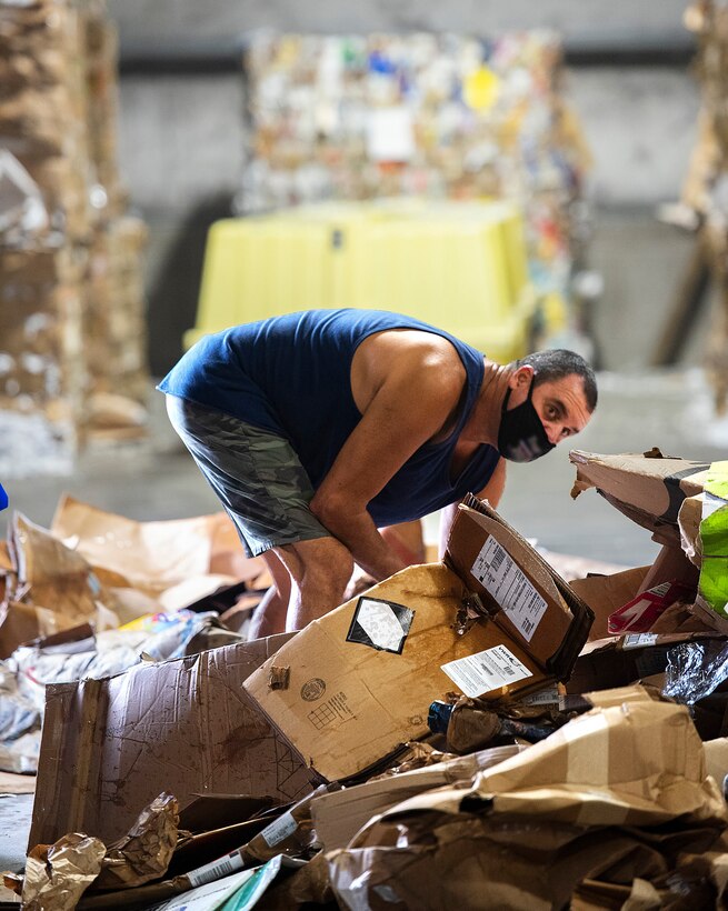 Ned Applegate, 88th Force Support Squadron, sorts through a pile of cardboard Sept. 22, 2021, in the Recycling Center at Wright-Patterson Air Force Base, Ohio. The center is run through a memorandum of agreement between 88 FSS and the 88th Civil Engineer Group.  (U.S. Air Force photo by R.J. Oriez)
