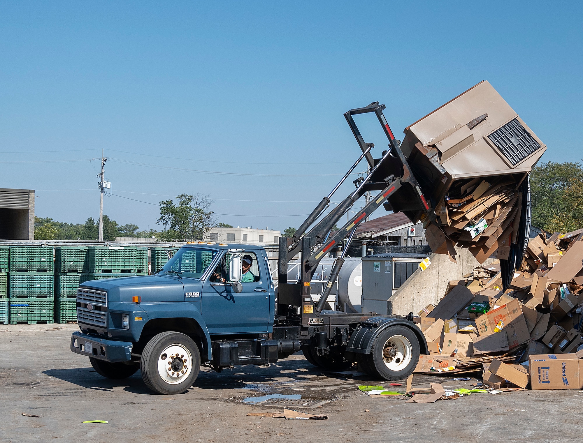 Timothy Fields, 88th Force Support Squadron, empties a recycling bin for cardboard Sept. 27, 2021, at Recycling Center on Wright-Patterson Air Force Base, Ohio. All the facility’s trucks are 20-30 years old, which presents maintenance challenges for center personnel. (U.S. Air Force photo by R.J. Oriez)