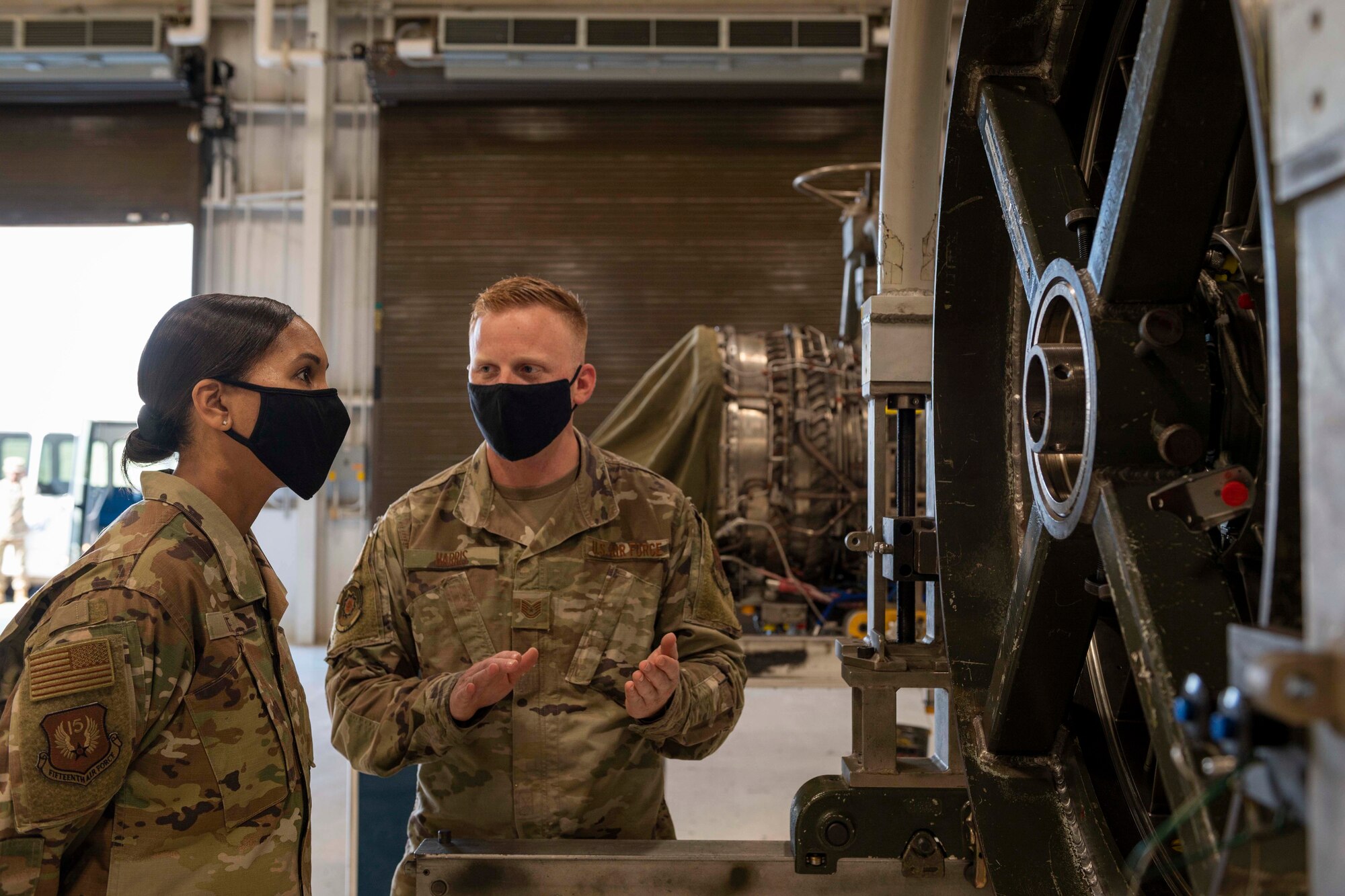 U.S. Air Force Chief Master Sgt. Sonia T. Lee, Fifteenth Air Force command chief, speaks with Tech. Sgt. Johnpaul Harris, Jet Engine Intermediate Maintenance production supervisor, during a visit to the Propulsion Flight at Seymour Johnson Air Force Base, North Carolina, Sept. 28, 2021.