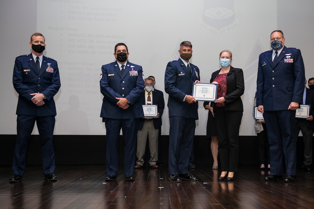 Col. Glenn Collins, 932nd Airlift Wing, commander, and Col. Sean Glasgow, 932nd Medical Squadron commander, present Dr. Katie Henderson, Vice President and Chief Medical Officer, Barnes Jewish Hospital and 932nd Medical Squadron honorary commander, with a certificate, Scott Air Force Base, Illinois, October 3, 2021. The Honorary Commanders program serves as a platform to connect the region’s civic leaders with profession of arms. (U.S. Air Force photo by Staff Sgt. Brooke Spenner)