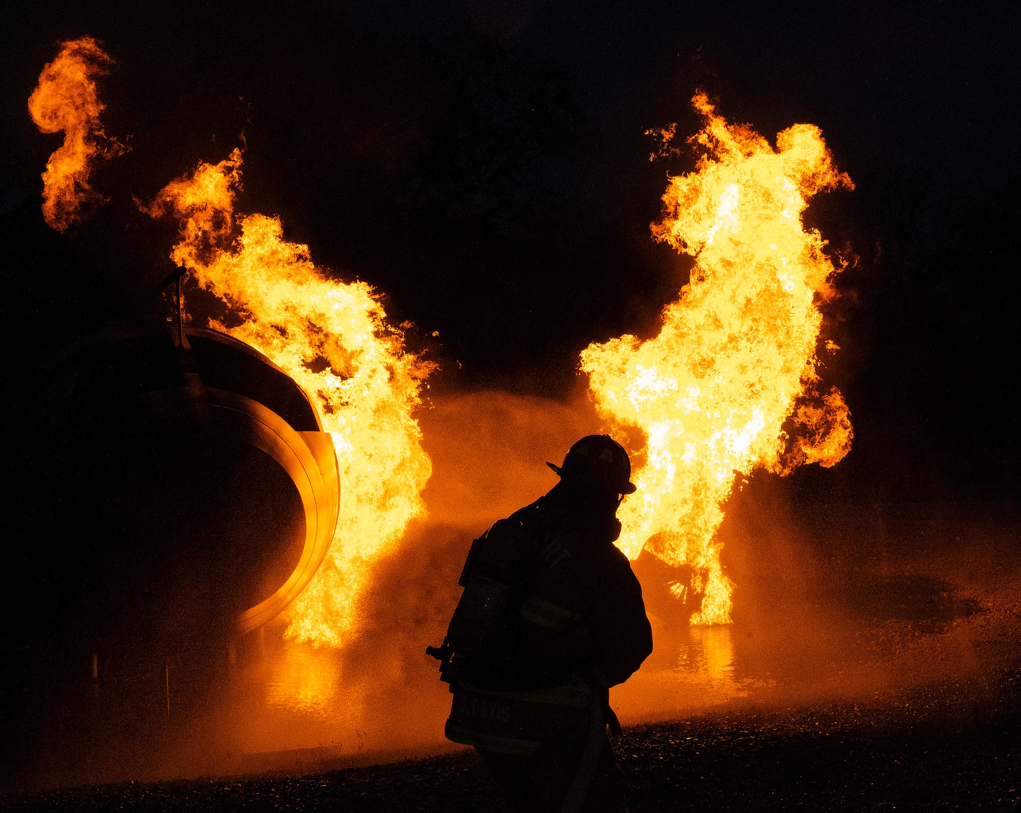 A Dayton International Airport firefighter attacks a training fire Oct. 5, 2021, at Wright-Patterson Air Force Base, Ohio. The 788th Civil Engineer Squadron Fire Department hosted the airport’s department so it could get required refresher training on aircraft fire. (U.S. Air Force photo by R.J. Oriez)