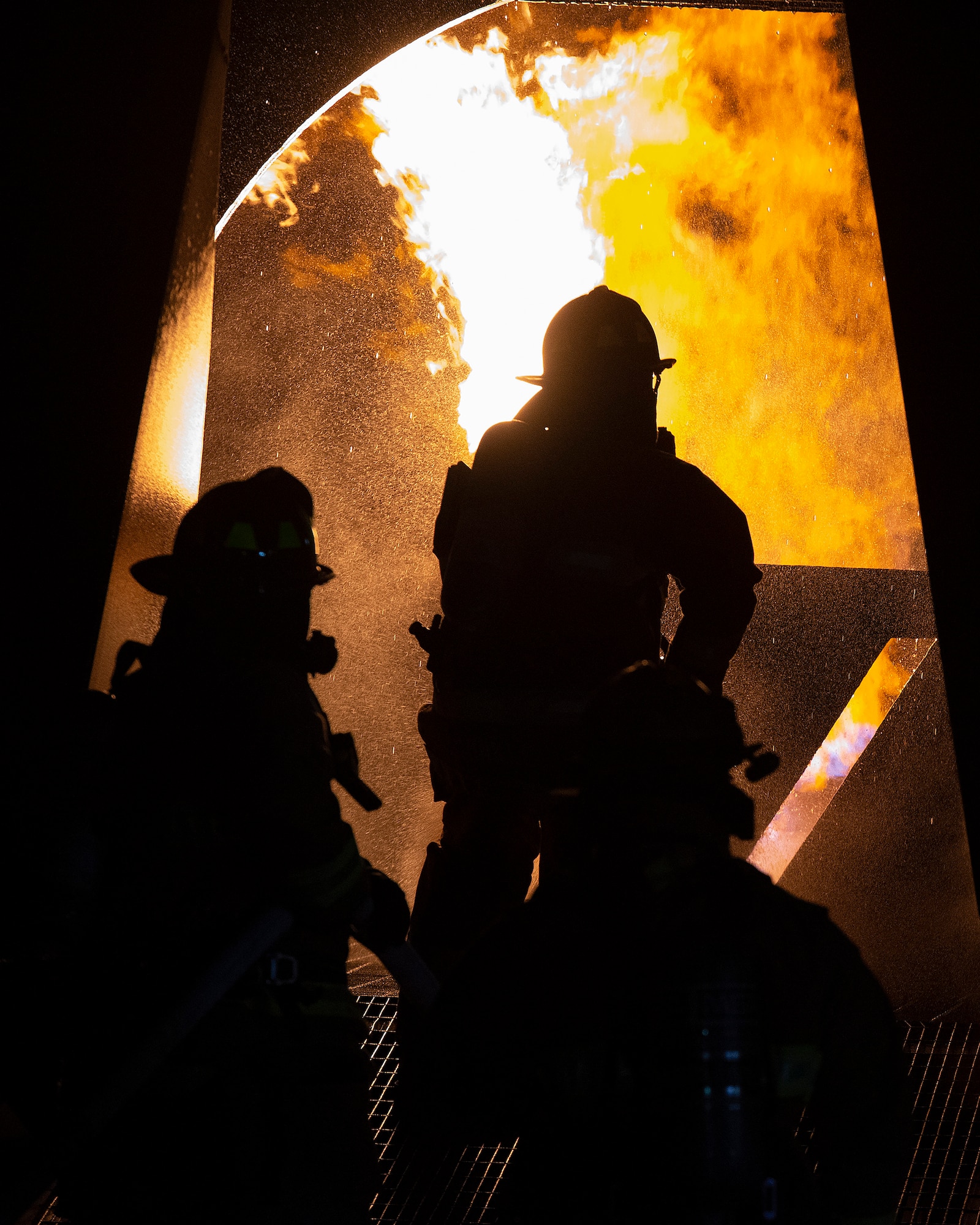 Dayton International Airport firefighters work their way into a replica aircraft’s burning fuselage during training Oct. 5, 2021, at Wright-Patterson Air Force Base, Ohio. The training included knocking down the fire and gaining fuselage access for rescue. (U.S. Air Force photo by R.J. Oriez)