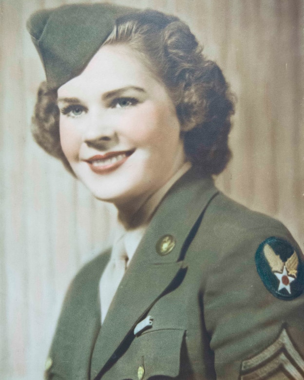 A woman military uniform poses for a photo.