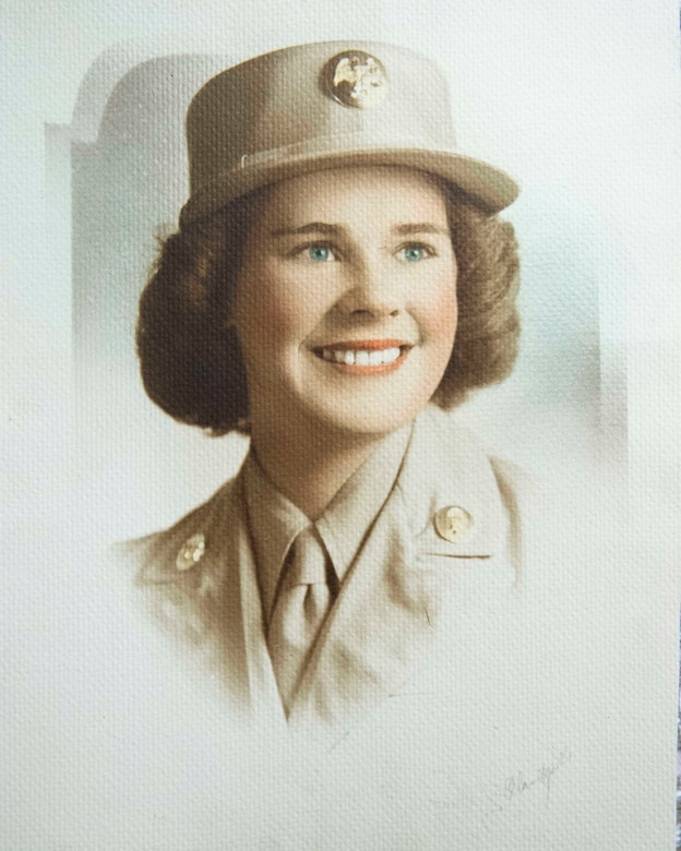 A woman military uniform poses for a photo.