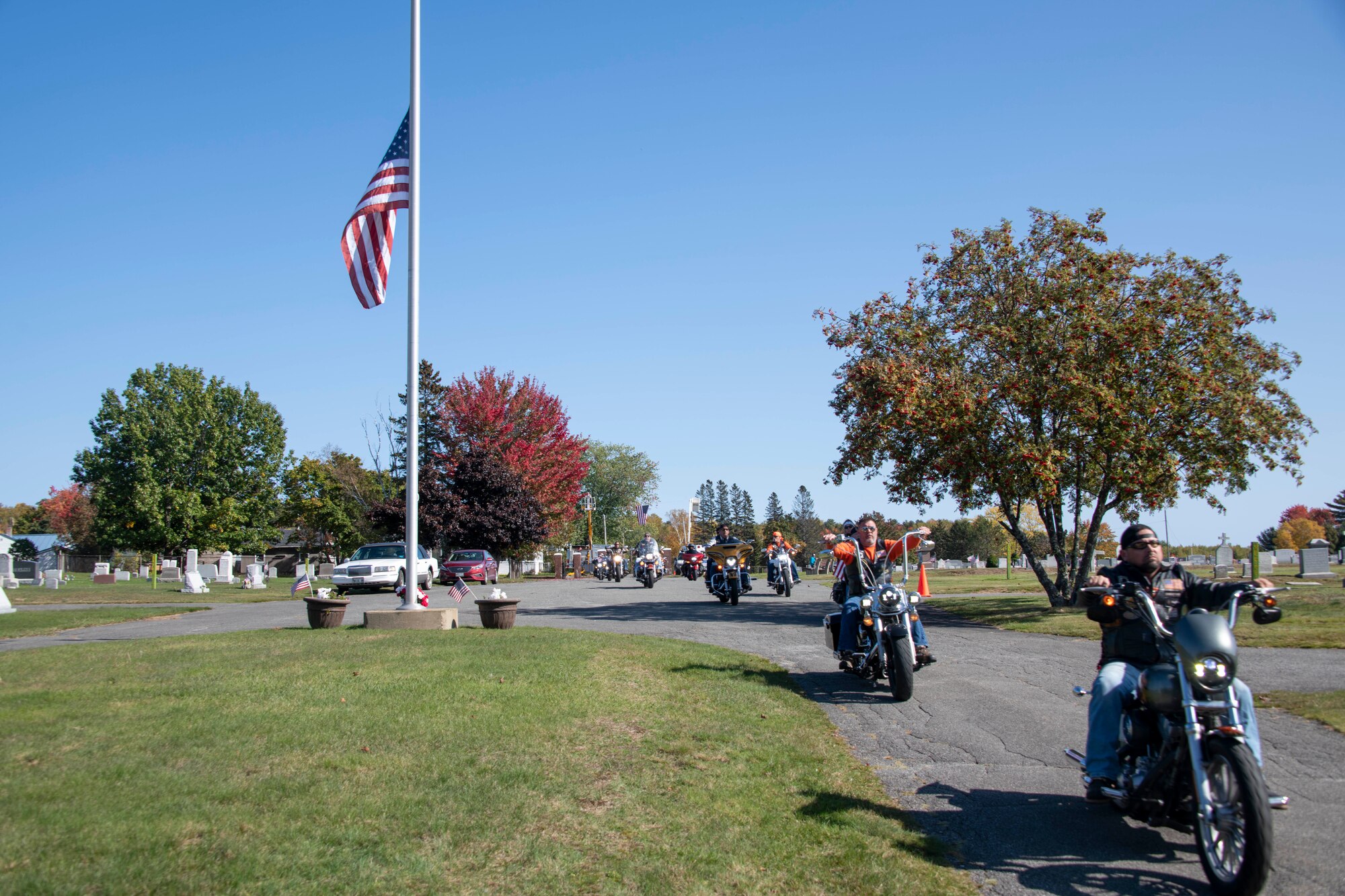 Motorcyclists from the Patriot Riders escort the procession team for the funeral of U.S. Army Air Forces 2nd Lt. Ernest Vienneau, former 97th Bombardment Group pilot, at Millinocket, Maine, Oct. 9, 2021. Groups like this form a voluntary honor guard at military burials, to help protect mourners from harassment and fill out the ranks at burials. (U.S. Air Force photo by Staff Sgt. Cody Dowell)