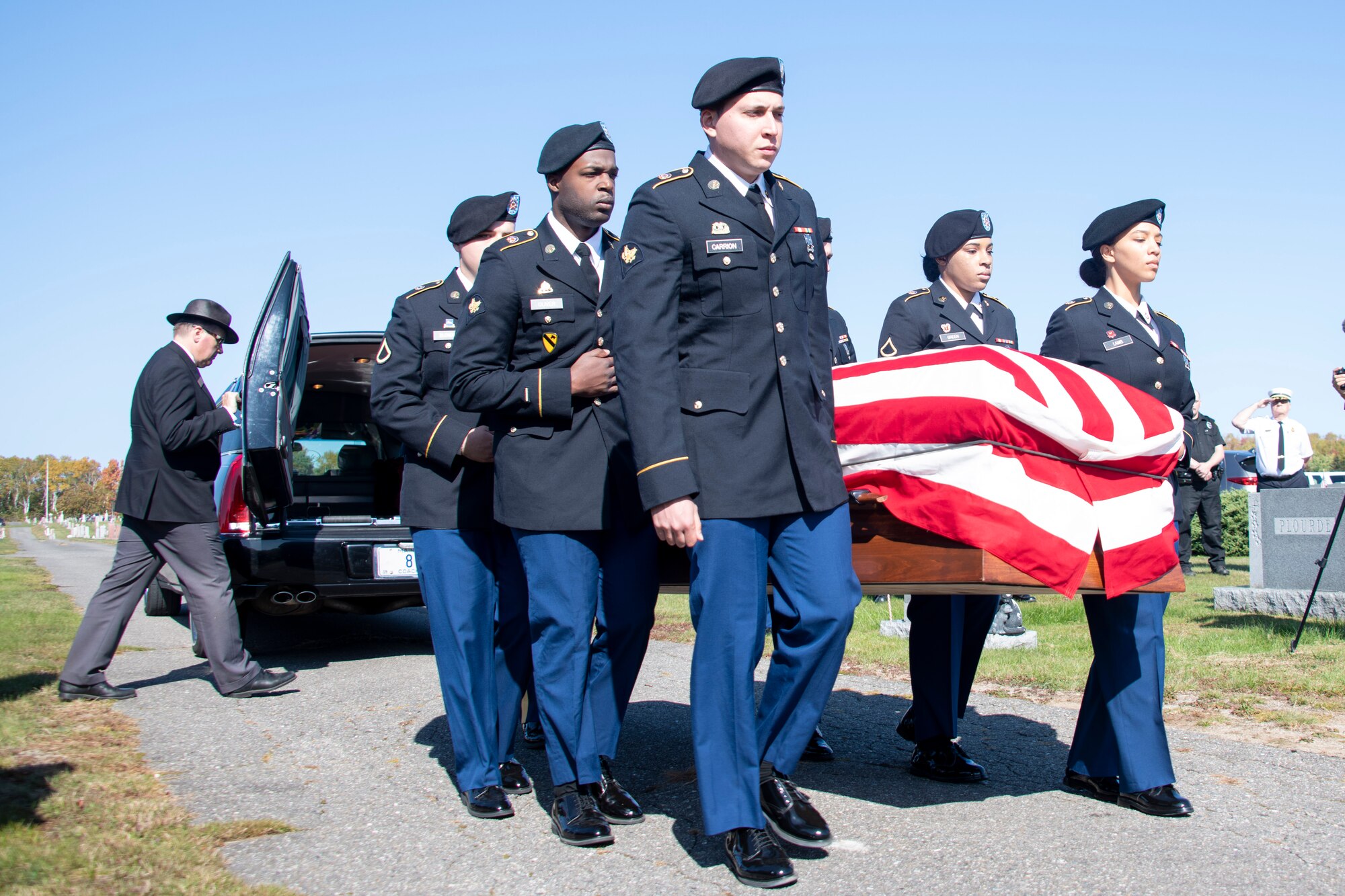 Members of the U.S. Army Honor Guard team from Fort Drum, New York, carry the casket of U.S. Army Air Forces 2nd Lt. Ernest Vienneau, former 97th Bombardment Group pilot, at Millinocket, Maine, Oct. 9, 2021. Military Honor Guard teams render professional military funeral honors, in accordance with service tradition, to all eligible veterans when requested by an authorized family member. (U.S. Air Force photo by Staff Sgt. Cody Dowell)