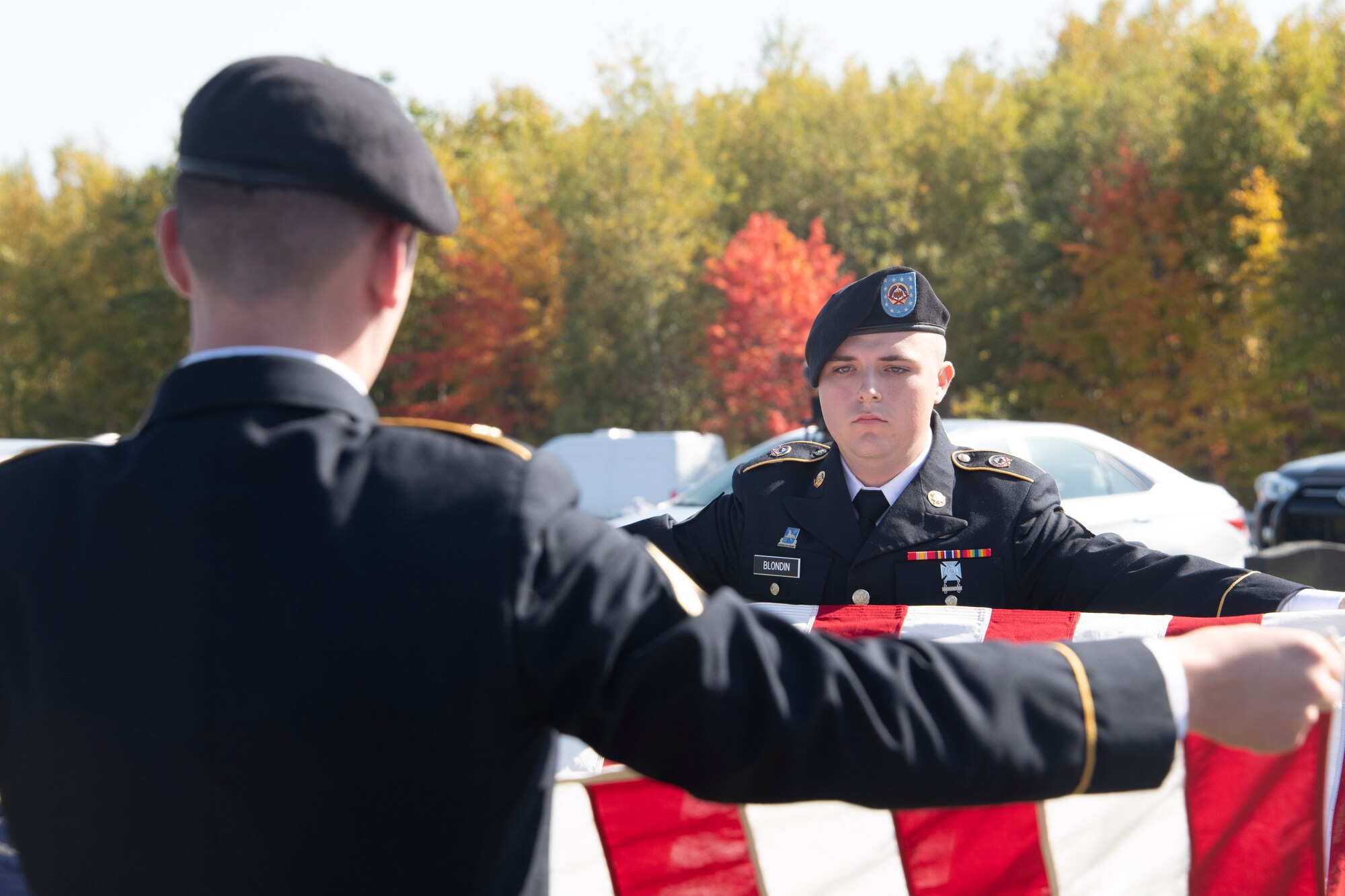 Members of the U.S. Army Honor Guard team from Fort Drum, New York, fold the American Flag for the funeral of U.S. Army Air Forces 2nd Lt. Ernest Vienneau, former 97th Bombardment Group pilot, at Millinocket, Maine, Oct. 9, 2021. The flag is ceremonially folded 13 times in a specific manner, with each fold having its own specific meaning. (U.S. Air Force photo by Staff Sgt. Cody Dowell)