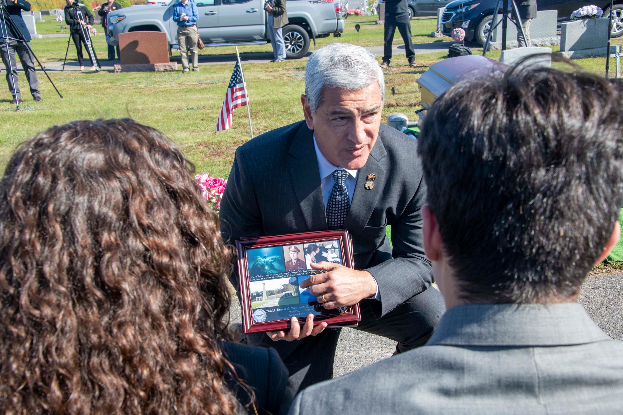 Kelly McKeague, Defense POW/MIA Accounting Agency (DPAA) director, presents a plaque from his agency to the family of U.S. Army Air Forces 2nd Lt. Ernest Vienneau, former 97th Bombardment Group pilot, during Vienneau’s funeral at Millinocket, Maine, Oct. 9, 2021. The DPAA vision is to provide a world-class workforce that fulfills the nation’s obligation by maximizing the number of missing personnel accounted for while ensuring timely, accurate information is provided to their families. (U.S. Air Force photo by Staff Sgt. Cody Dowell)