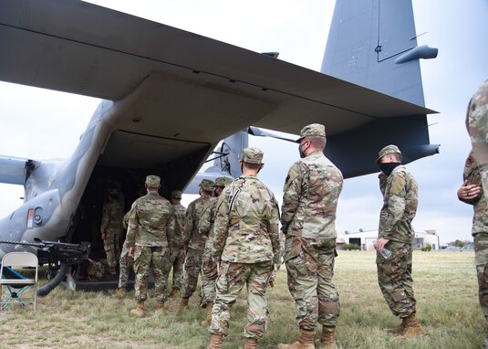 Airmen await their turn to view the interior of the CV-22 Osprey