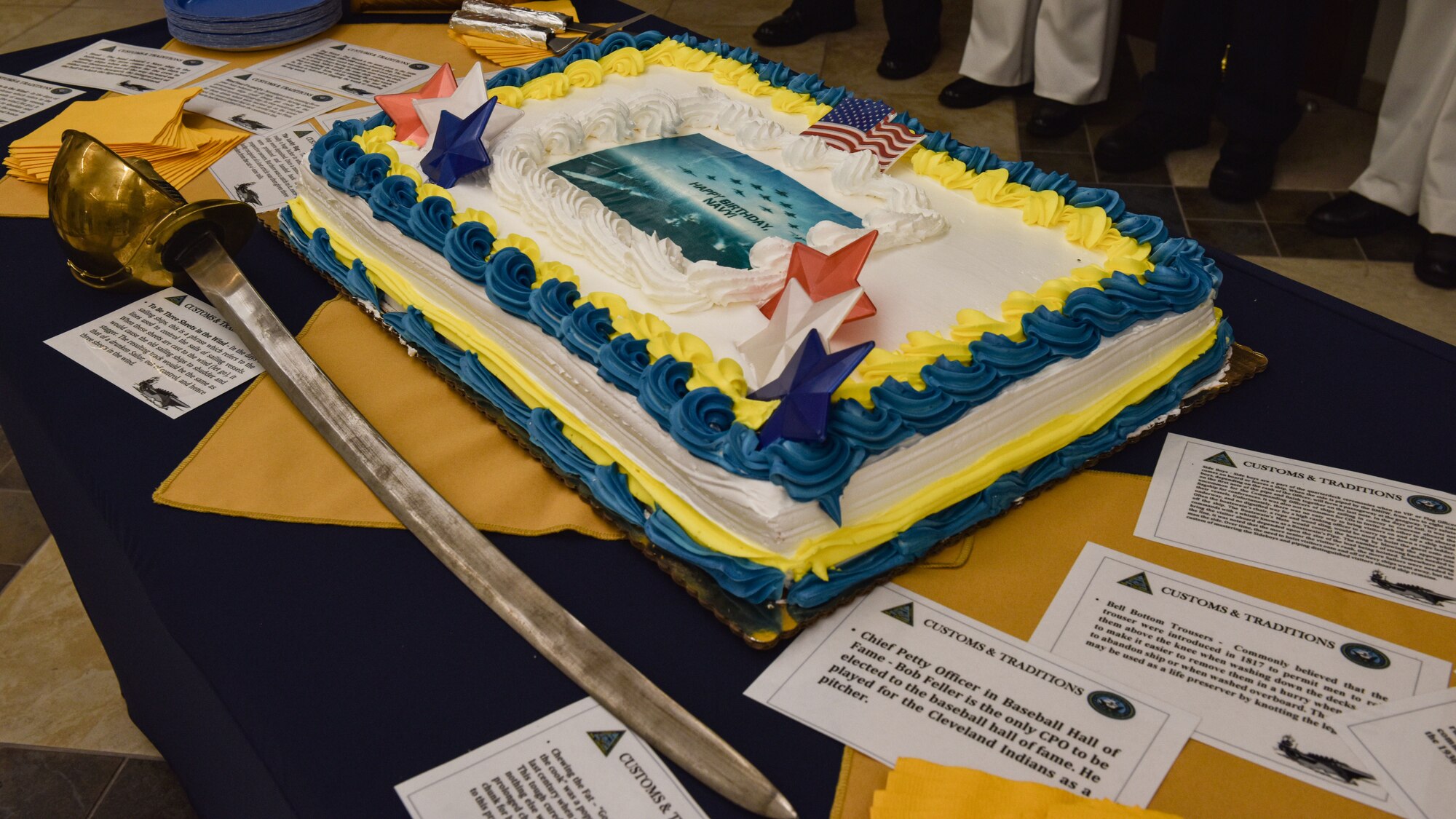 Sailors and Joint partners gathered at the Lakehurst Flight Deck Community Center to celebrate the U.S. Navy’s 246th birthday at Joint Base McGuire-Dix-Lakehurst, N.J., Oct. 13, 2021. The ceremonial cake was surrounded by cards displaying facts about the Navy that those in attendance could read before the cutting. (U.S. Air Force Photo by Staff Sergeant Shay Stuart)