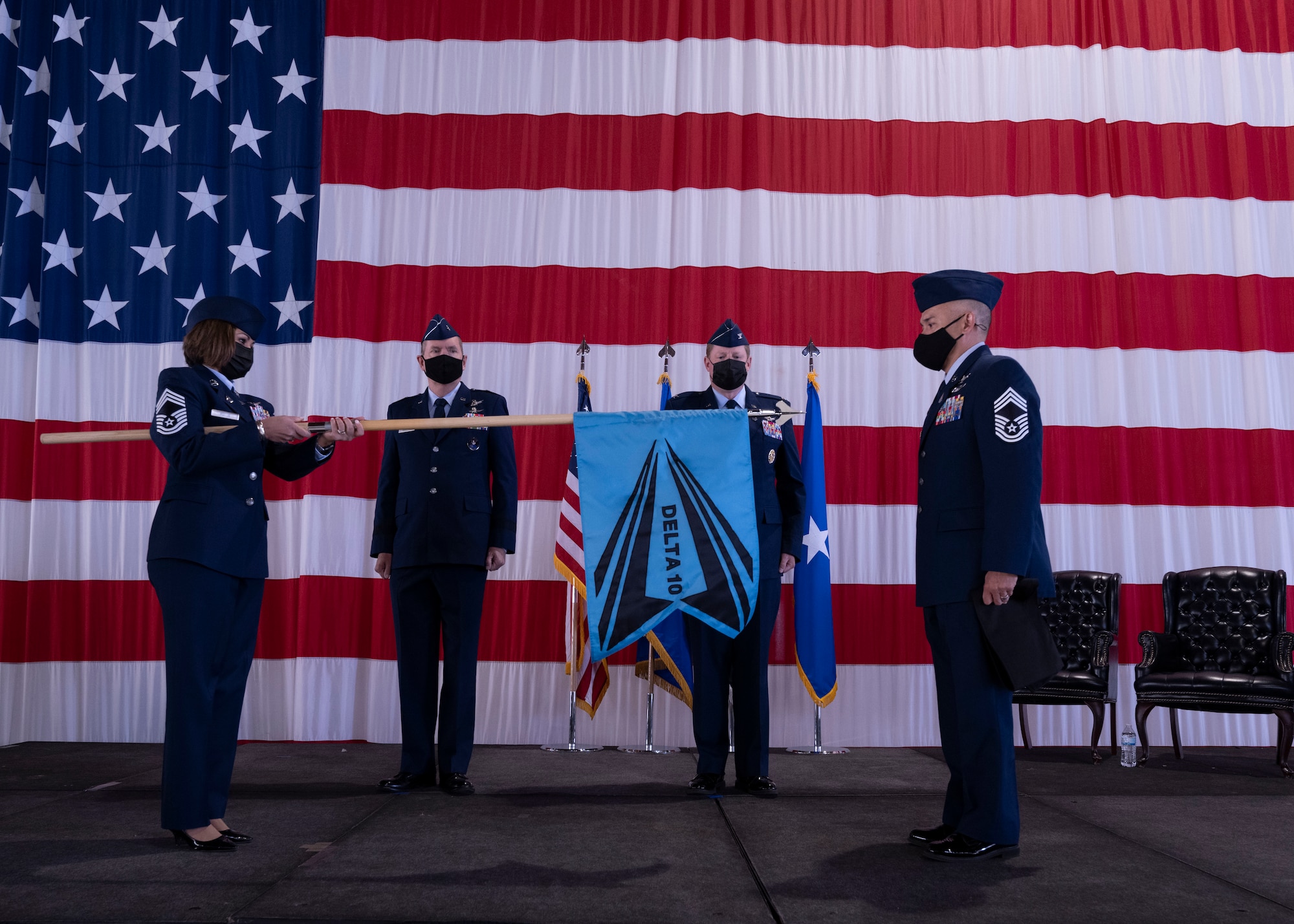 U.S. Space Force Chief Master Sgt. Karmann-Monique Pogue Space Delta 10 – Doctrine and Wargaming senior enlisted leader, left, and U.S. Space Force Chief Master Sgt. James Seballes, Space Training and Readiness Command SEL, reveal the DEL 10 guidon during the activation ceremony at Peterson Space Force Base, Colorado, Sept. 30, 2021. DEL 10 is one of five deltas that fall under the Space Training and Readiness Command. The command provides oversight for education and training. (U.S. Space Force photo by Staff Sgt. Matthew Coleman-Foster)