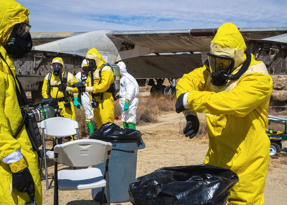 Airmen from the Explosive Ordnance Disposal Flight, 812th Civil Engineer Squadron, remove their PPE during a "Broken Arrow" training exercise on Edwards Air Force Base, California, Sept. 28. (Air Force photo by Katherine Franco)