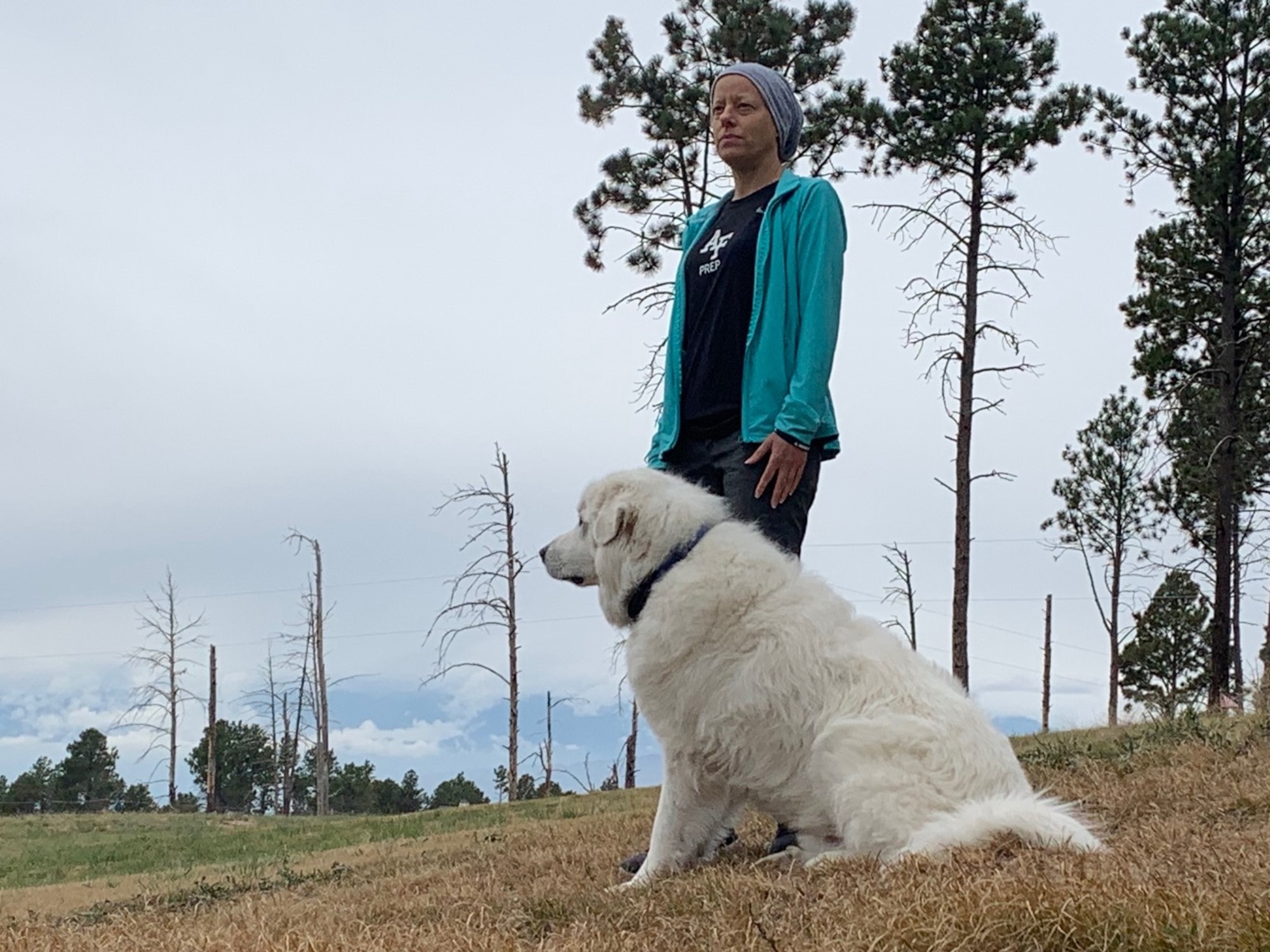 Image of a women standing with a dog.