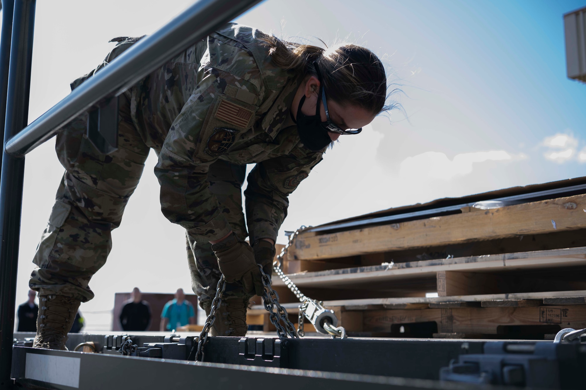 woman locking cargo to a vehicle