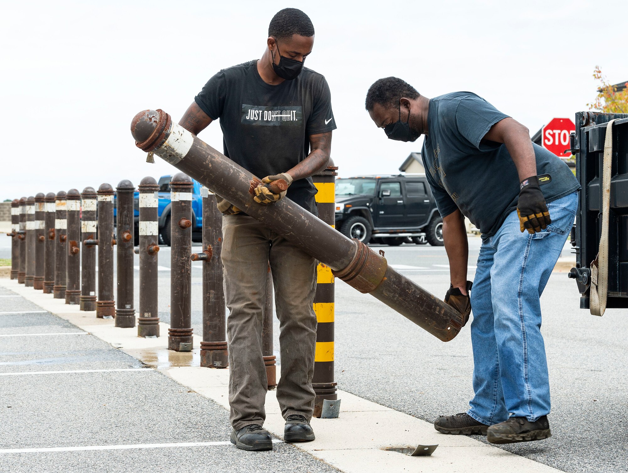 From the left, Kevonte Jackson and Earl Batten, both from the 436th Civil Engineer Squadron horizontal shop, install bollards during a Force Protection Major Accident Response Exercise at Dover Air Force Base, Delaware, Oct. 6, 2021. The three-day exercise tested the response capabilities of Team Dover through various scenarios in an effort to strengthen their ability to provide rapid-global mobility in challenging conditions. (U.S. Air Force photo by Roland Balik)