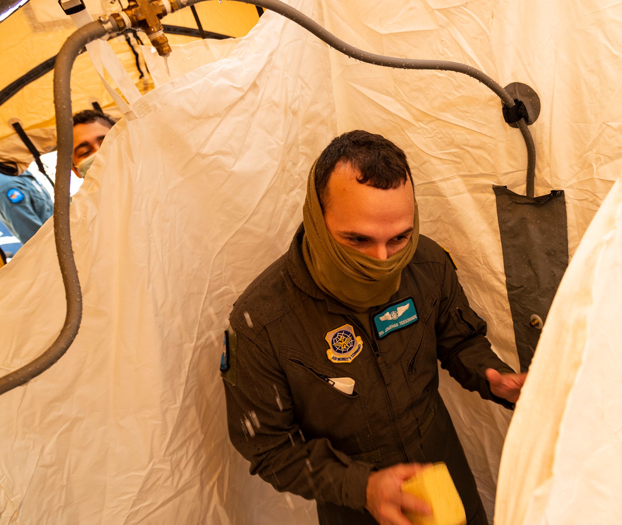 Senior Airman Jonathan Teissonniere, 9th Airlift Squadron loadmaster, simulates decontamination procedures during a Force Protection Major Accident Response Exercise at Dover Air Force Base, Delaware, Oct. 7, 2021. The three-day exercise tested the response capabilities of Team Dover through various scenarios in an effort to strengthen their ability to provide rapid-global mobility in challenging conditions.(U.S. Air Force photo by Roland Balik)