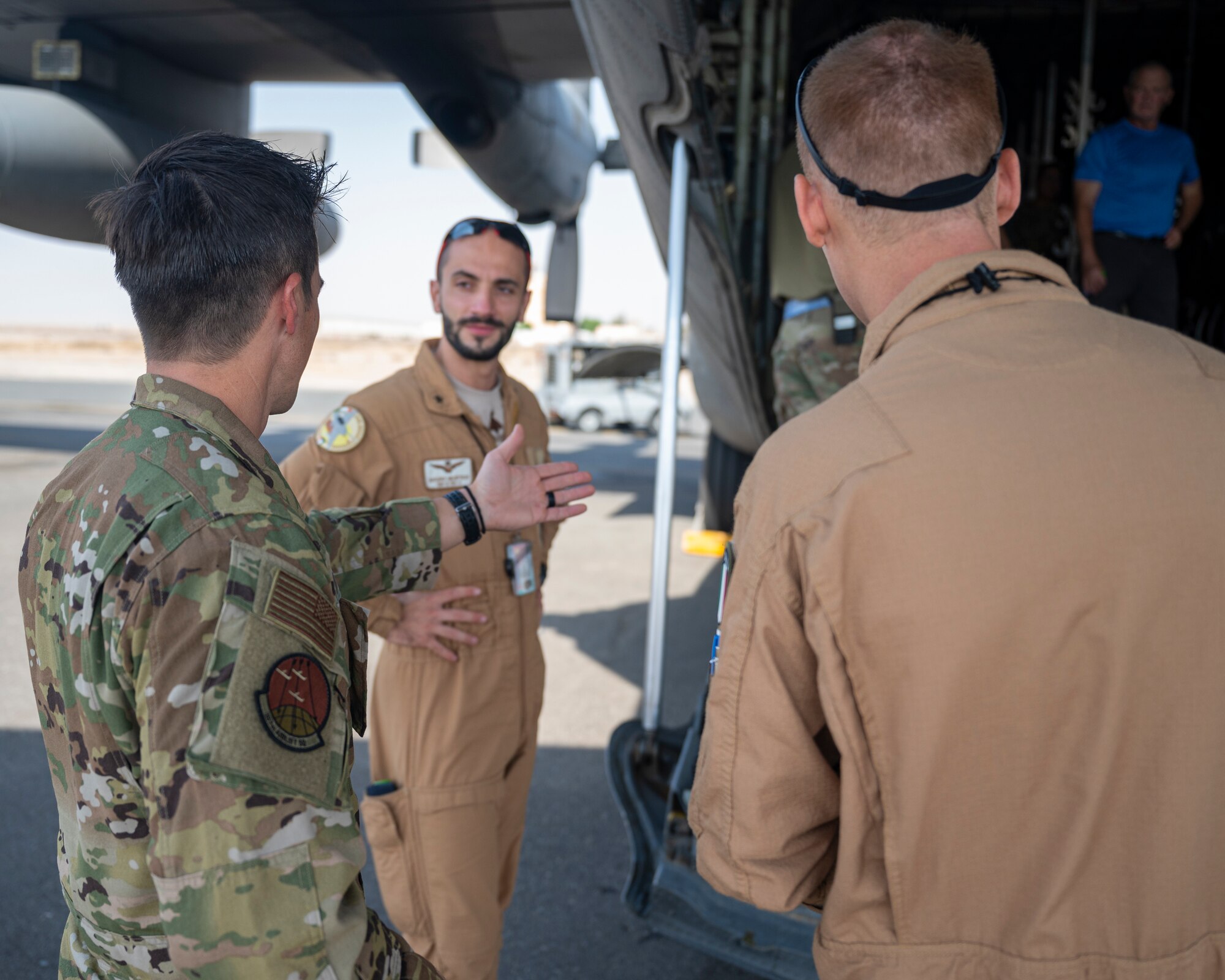 U.S. Air Force Maj. Scott Graves, a pilot assigned to the 779th Expeditionary Airlift Squadron, interacts with members of the Italian Air Force during a C-130H Hercules tour at Ali Al Salem Air Base, Kuwait, Oct. 9, 2021.
